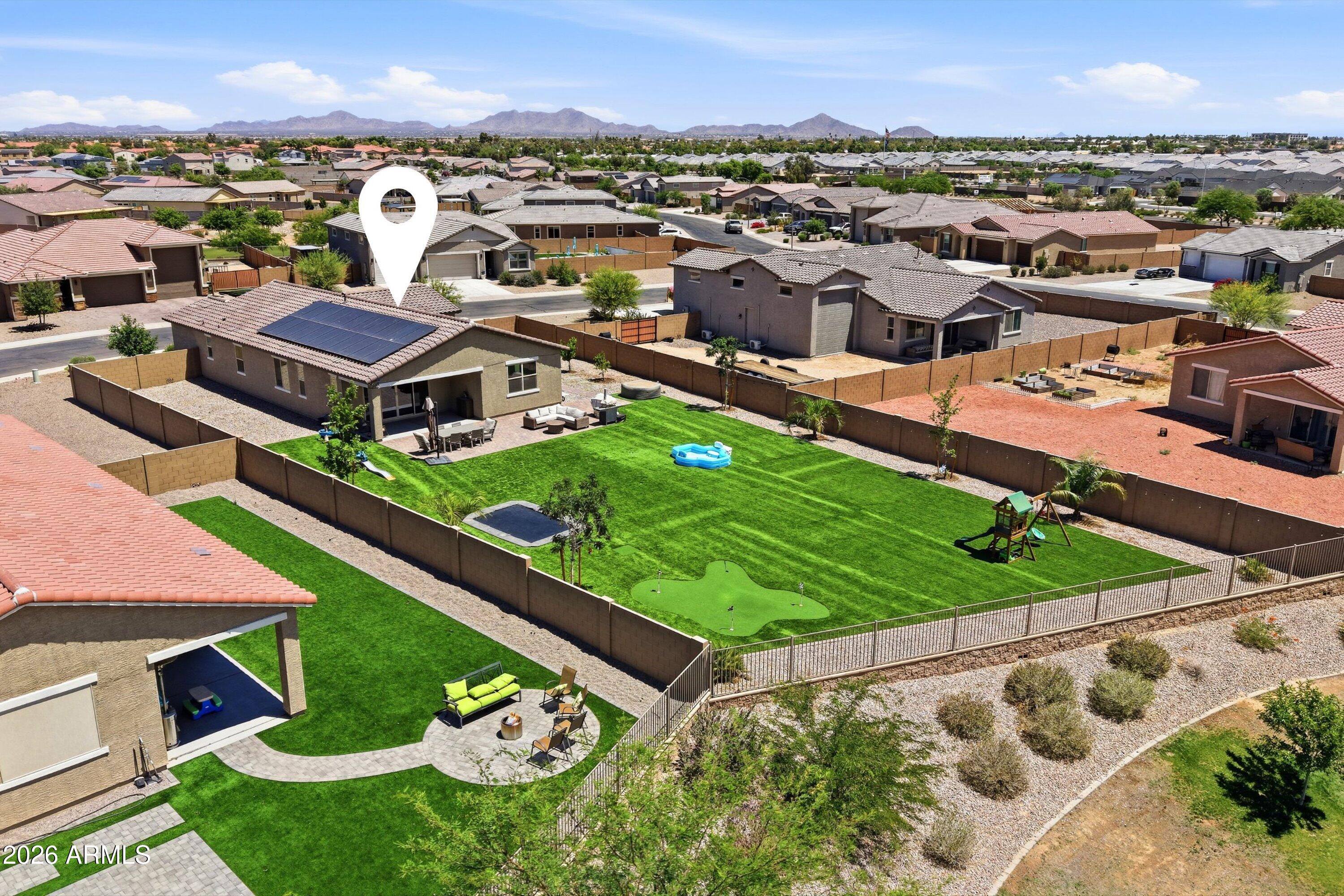 Discover the perfect blend of comfort, efficiency, and space in this beautifully upgraded Casa Grande home. Built in 2024 and loaded with features that truly set it apart.

Take advantage of a rare 5.375% VA assumable loan, offering incredible value in today's market. This thoughtfully designed home features 3 bedrooms, a versatile den, and 3 full bathrooms, providing flexibility for families, guests, or a home office setup.

Situated on an expansive nearly 16,000 SF cul-de-sac lot, you'll enjoy exceptional privacy with no direct neighbors behind and stunning mountain views. The backyard is an entertainer's dream--complete with citrus and shade trees, low-maintenance gravel, pet and kid friendly artificial turf, and even an in-ground trampoline. Whether hosting gatherings or relaxing under the Arizona sky, this outdoor space delivers.

Inside, the home showcases a beautifully upgraded kitchen with a massive walk-in pantry, ideal for both everyday living and entertaining. The open living area features automatic blinds, adding comfort and convenience.

Additional highlights include: Solar panels for energy efficiency and savings, 3-car garage with a 50-amp EV charger already installed, Space and HOA allowance (with approval) to add an RV gate and backyard RV parking, Owned water softener and whole-home filtration system, Builder warranties still transferable for peace of mind.

Even better, all appliances convey, and several extras are included: inflatable hot tub, Murphy bed, living room curtains, outdoor playground set, grill, and outdoor couch. Additional furnishings may be available via separate bill of sale.

This home is truly move-in ready and checks every box. From modern upgrades to unbeatable outdoor living.