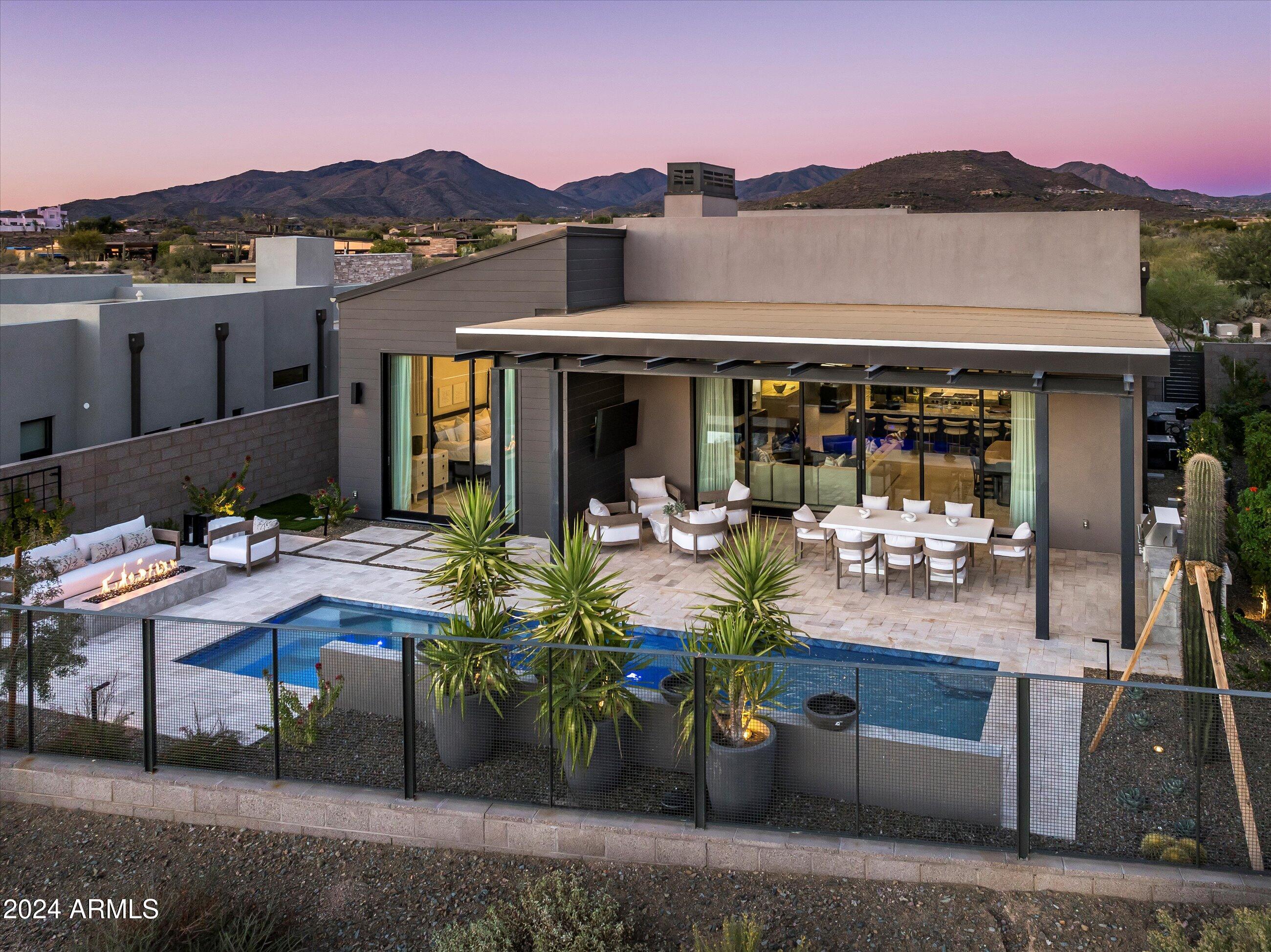 Experience luxury living in this exquisite Camelot Villa, perfectly positioned with southwest orientation overlooking the 12th Fairway of Desert Mountain's Seven Course. Enjoy breathtaking Black Mountain views & stunning painted sky sunsets.
The elegantl home features a dramatic drop ceiling in the great room, striking contrasting cabinetry, a Subzero/Wolf appliance package, a waterfall island, and 10-foot glass pocket doors blending indoor& outdoor spaces. All en-suite bedrooms offer privacy with a split floorplan.
The resort-style backyard includes a heated pool and spa with four water features, a built-in BBQ, and a firepit, perfect for entertaining. Additional highlights include a 3-car tandem garage, available full golf membership, &  designer furnishings on a separate bill of sale