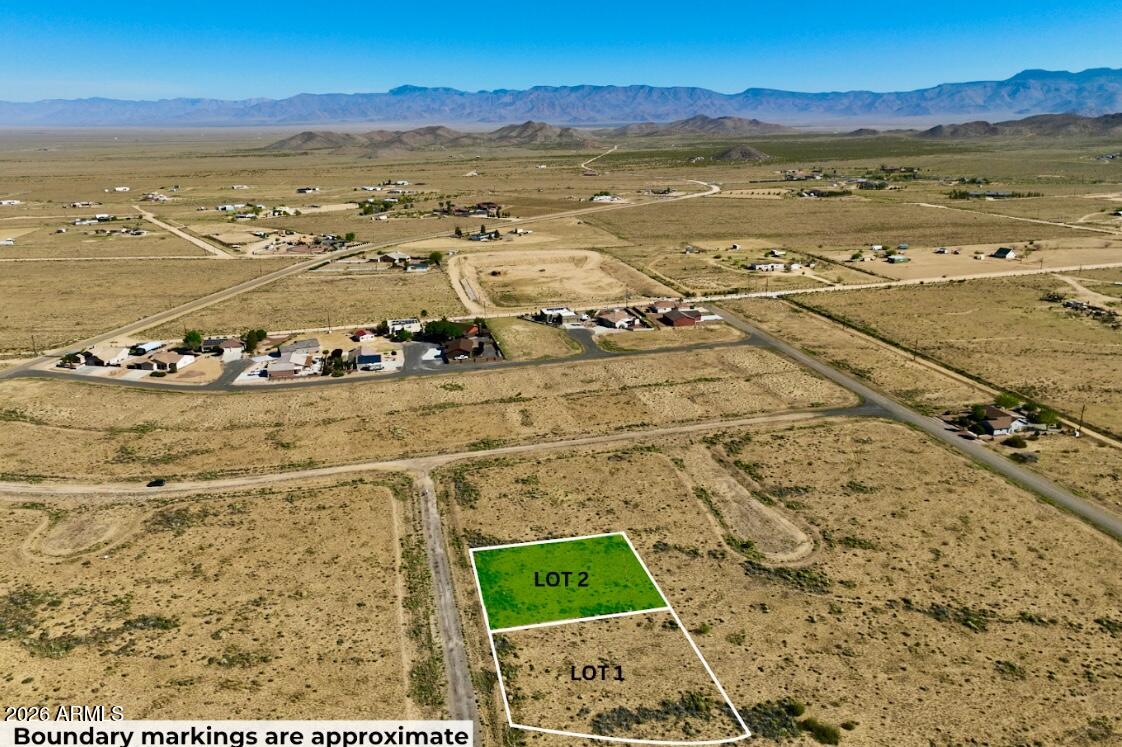 Double lot in Kingman, AZ--0.25 acres of space and opportunity. Build your site-built home with room for a shop, garage, or more. Power approx. 585 ft away. Located in a growing area with open views, privacy, and easy access to town, Route 66, Las Vegas, and Lake Havasu. OWNER WILL CARRY