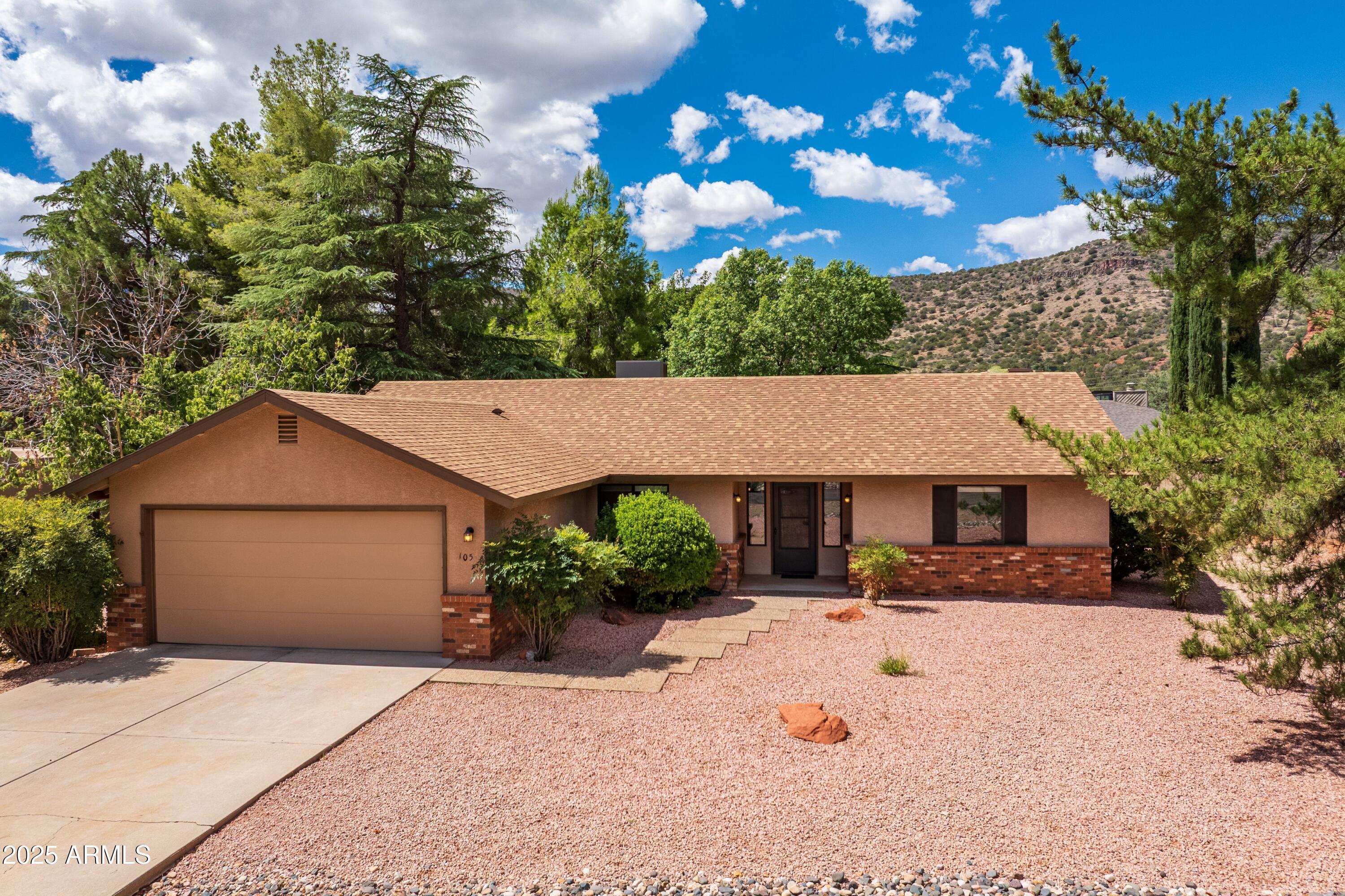 Beautifully updated 3 bedroom, 2 bath all electric home with a split bedroom floor plan, 2-car attached garage, located on a quiet street near 2 golf courses.  The kitchen & both bathrooms have been completely updated, including all new light fixtures, bathroom vanities & faucets, ceiling fans, and full interior paint. High grade laminate and tile flooring throughout, no carpeting! Living room with a wood burning stove, new HVAC system installed 2022.  Generous size master bedroom with sliding glass doors out to the covered rear patio. Double sinks, separate toilet room, and 2 closets in the master bathroom.  2 guest bedrooms with a full bath between them.  Sliding glass doors from the dining area out to the covered rear patio and back yard, lots of shade trees.  Come see all the changes!