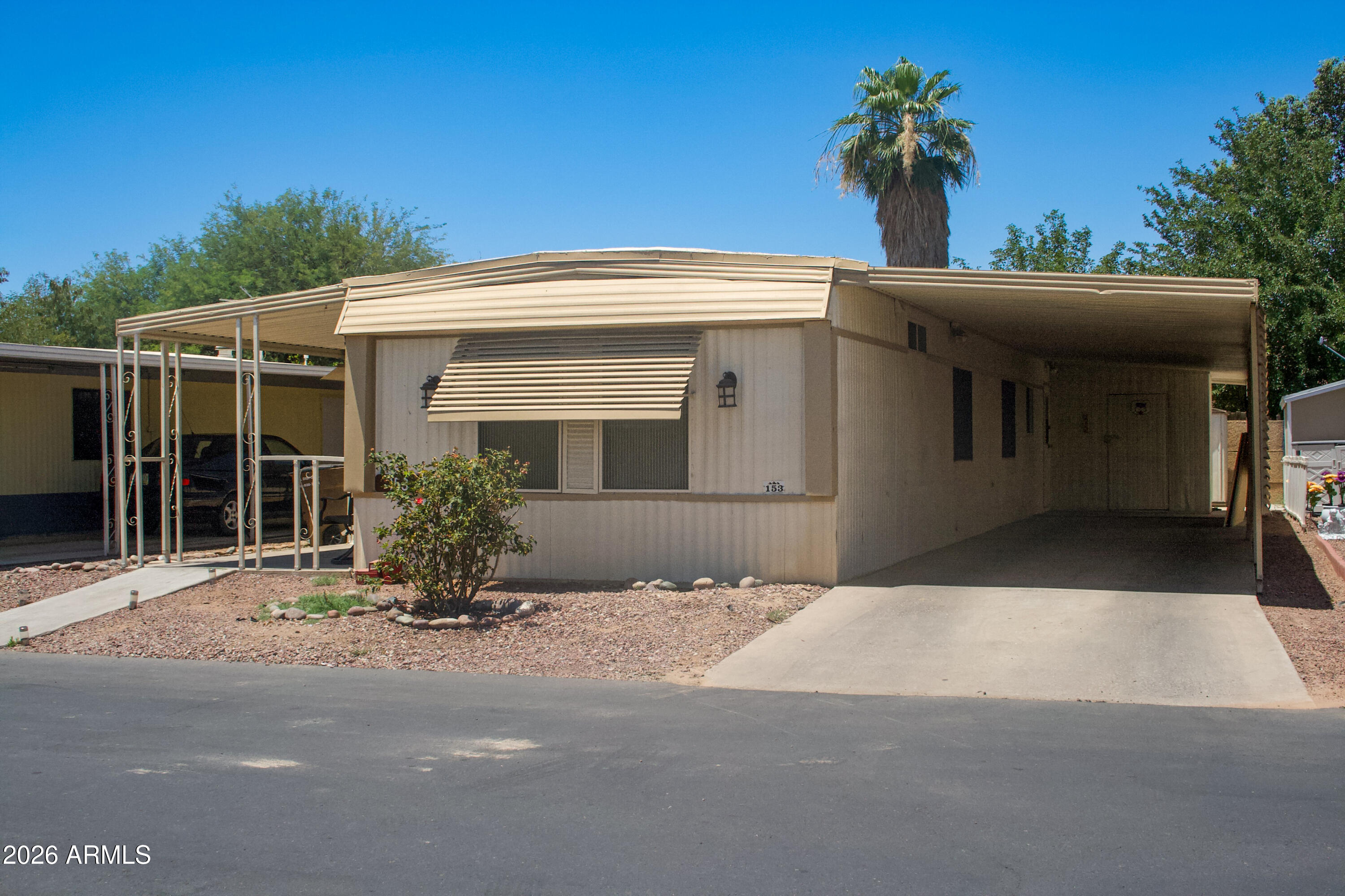 Beautifully remodeled manufactured home featuring 2 bedrooms, 2 bathrooms, and a bonus room ideal for a home office, hobby room, or additional living space. This move-in ready home offers an open floor plan with a spacious living area flowing into the upgraded kitchen, complete with modern cabinetry, updated countertops, and ample storage. Interior upgrades include updated flooring, remodeled bathrooms with stylish finishes, and spacious bedrooms, including a primary suite with a large closet and private bath. Exterior features include covered parking, low-maintenance landscaping, and a large storage shed/workshop area. Well-maintained and ready for its next owner!