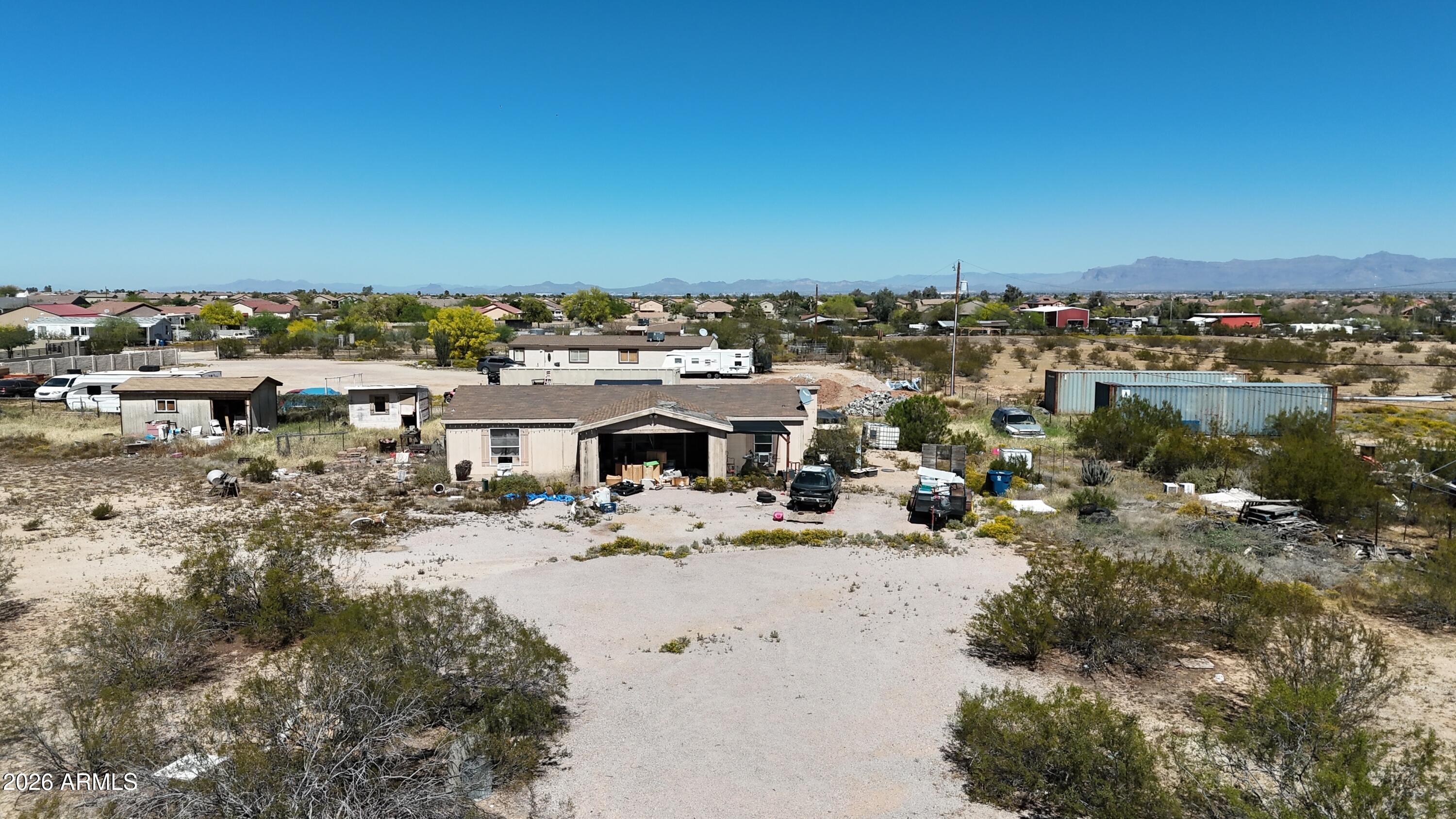 Exceptional investment opportunity in the highly desirable Chandler Heights Ranches area, surrounded by newly built custom homes selling for $1M+. This NO HOA property sits on an expansive 54,886 sq ft corner lot, offering rare flexibility and multiple access points with two separate gates--ideal for future development, RV storage, or expanded use.

The existing home features a split floor plan, vaulted ceilings, and abundant natural light from a kitchen skylight. With a large pantry and interior washer/dryer hookups, the structure provides a solid footprint for renovation.

This property presents multiple value-add strategies: renovate and occupy, hold as a rental, or take advantage of the oversized lot to build a custom dream home while converting the existing residence into a guest house or casita (buyer to verify). The surrounding growth and high-end construction make this a prime candidate for redevelopment or long-term appreciation.
