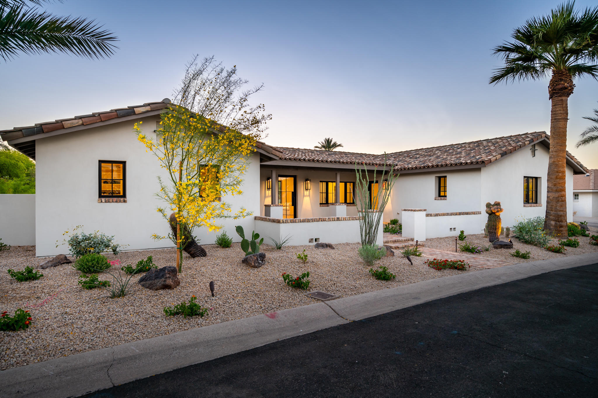 Timeless Santa Barbara inspired home located in the highly coveted, gated community of Mountain Shadows West in Paradise Valley, Arizona!  Built by luxury home builder Genova Detwiler and completed in March 2021, the 4-bedroom, 3.5 bath open floor plan evokes a soft, neutral palette with accents of walnut throughout. Interior features include vaulted ceilings, wide plank oak flooring, custom designed fireplace and oversized sliding doors that open to the back patio for quintessential indoor/outdoor Arizona  living. The split master suite includes views that frame Camelback Mountain, a large master bath with soaking tub and a glass encased walk in shower and oversized master closet. The designer kitchen features a massive island, a custom crafted walnut dining table and breakfast banquette, a large walk in storage pantry and a butler's pantry. Relax on the back patio while enjoying the spectacular view of Camelback towering above the lush green golf course. Gather around the outdoor fireplace in the evening for entertaining and stargazing. No expense was spared on the professionally designed landscape and hardscape. The garage includes an air conditioned third bay that can be used as an office, studio or workshop.  Do not miss out on this rare opportunity to own a newly constructed gem in the heart of Paradise Valley!