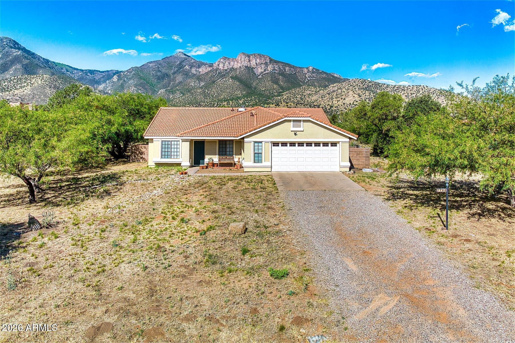 Here's a great home in Foothills Ranch that sits on nearly 2 acres of land with awesome views of the Huachuca Mountains.  The home features a formal living and dining along with a family room complete with fireplace and a breakfast nook.  You'll find 4 bedrooms with the primary being large and one room that was used as an office.  Out back you'll find a swimming pool that is great for the family to play and cool off in the summer breezes.  There's a covered patio and an added kitchen and entertaining space that you will love.  This home has just had PEX water lines installed throughout the home.  The home has so many possibilities!  You won't want to miss this great home at a very reasonable price.