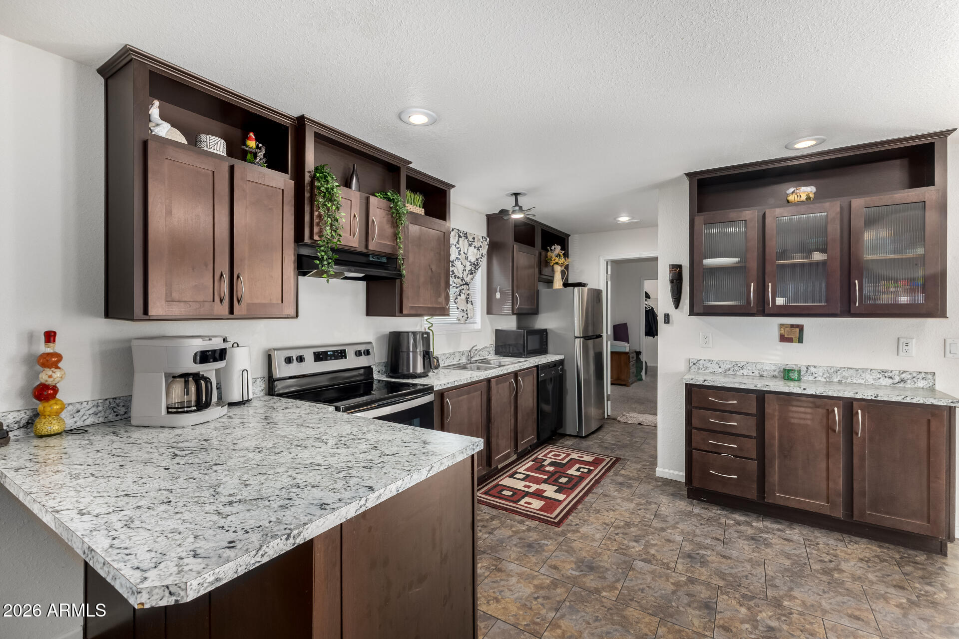 Step into Rosewood Estates, a gated community in the heart of El Mirage where comfort meets convenience. This beautifully maintained 2016 home features 3 bedrooms, 2 bathrooms, and an inviting open layout enhanced by stylish modern flooring. The bright, airy kitchen seamlessly connects to the living area, creating the perfect space for gatherings or quiet evenings at home. With parks, shopping, and dining just minutes away, this home offers an effortless blend of simplicity, comfort, and everyday ease.