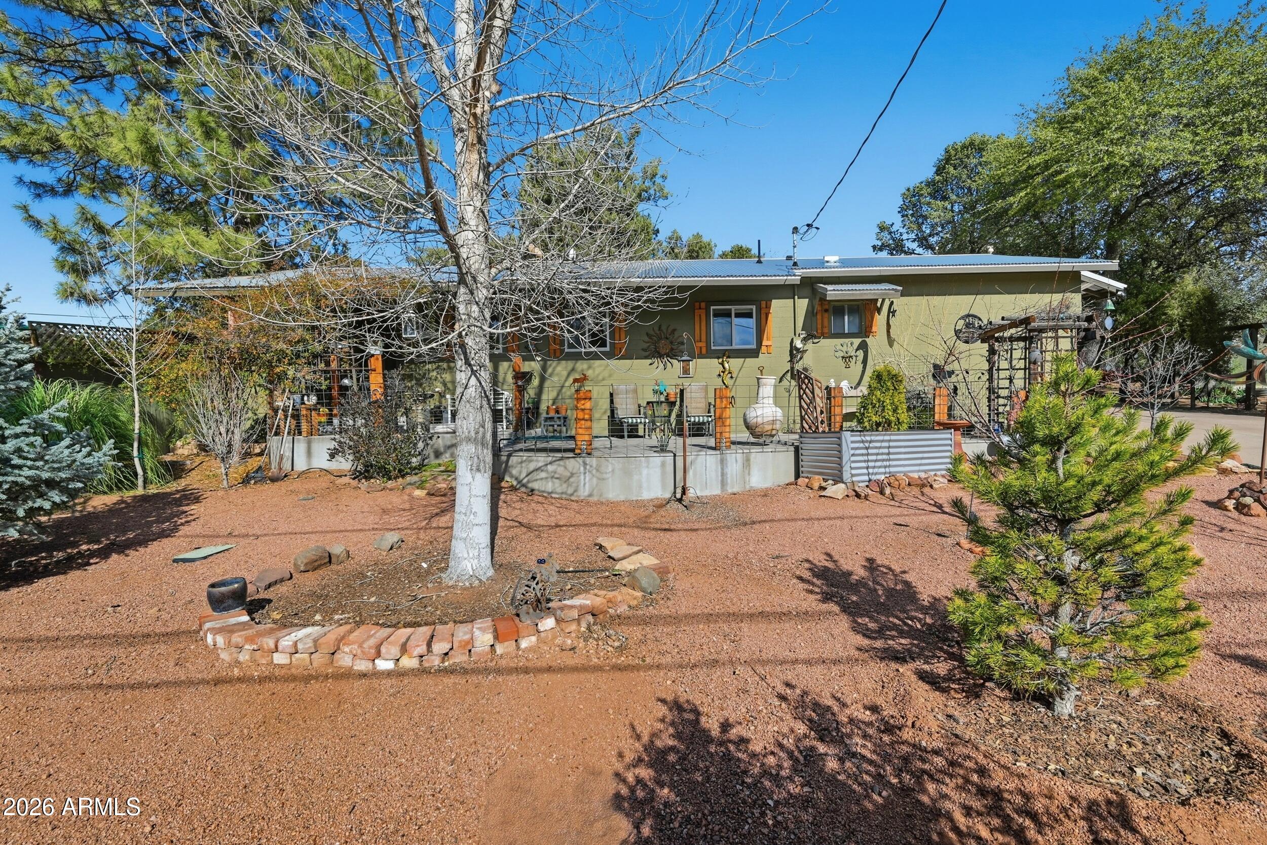 This 2 br 2 ba home is built with 12 inch block construction and a newer steel roof making it very energy efficient, lots of upgraded features throughout. Primary bedroom has a large 13x8 closet. Bathrooms and Kitchen are updated with new cabinetry, counters, fixtures and newer appliances. Beautiful wood floors, base boards and doors. This home is available partially furnished. Located within town limits yet offering a true out-of-town feel, this rare property spans two oversized lots filled with mature trees, lush landscaping, and abundant greenery, creating exceptional privacy. The fully fenced and gated property with a solar-powered gate backs to an undeveloped area enhancing the sense of space and seclusion. RV parking both lots have large gates. A property-wide drip system combined with a French drain watering system helps keep the landscaped grounds affordably watered year-round. incredible park like setting including an outdoor shower. Enjoy desirable north-south exposure and multiple producing fruit trees--apple, plum, apricot, cherry, and peach. Three large sheds and two large carports This sale includes parcels 302-41-064 and 302-41-065 aka 606 E Luke Dr and 608 E Luke Dr. All electric home but gas available. Buyer to verify all facts and figures.