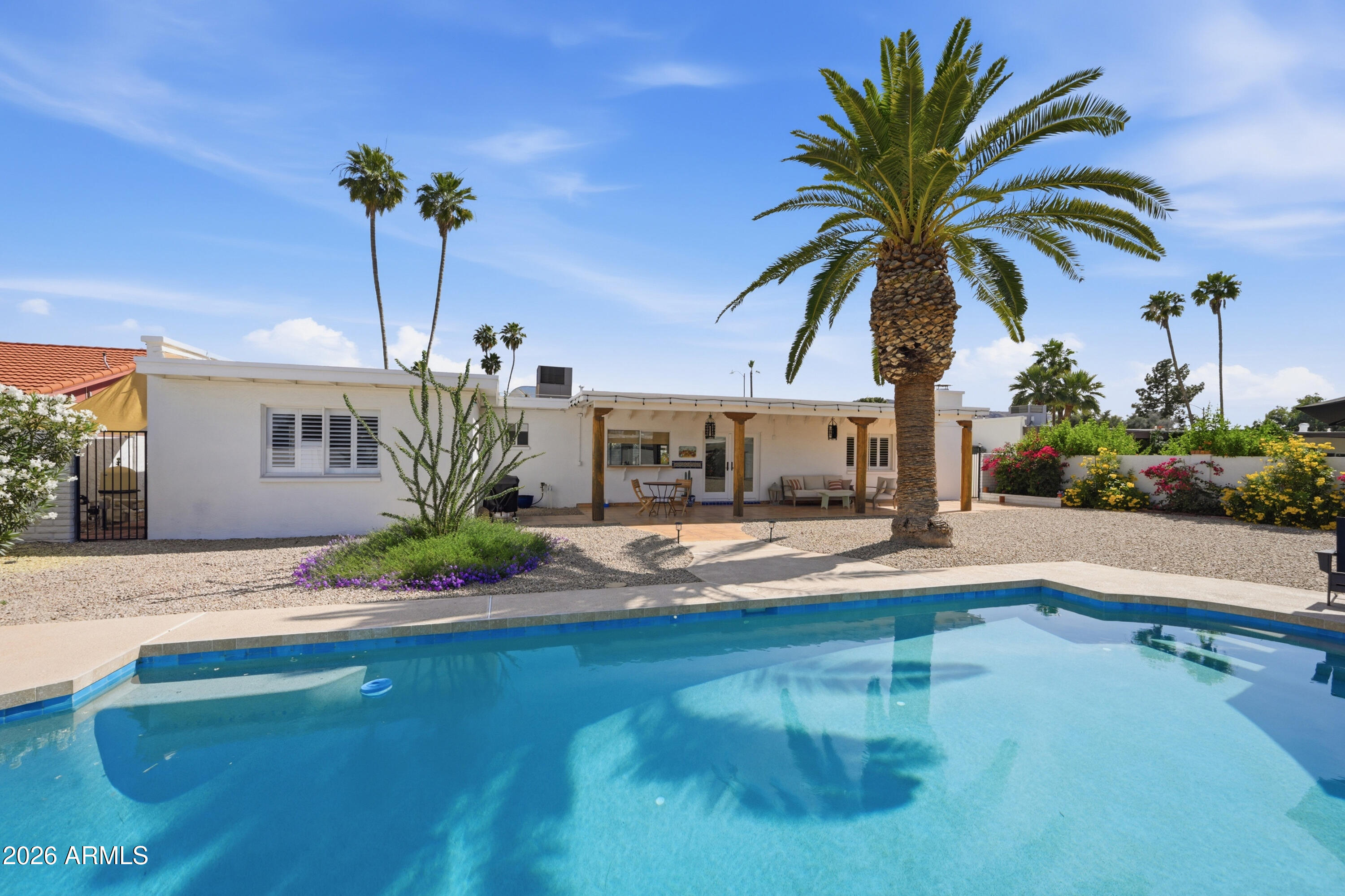 Located in the heart of Moon Valley, this beautiful home has been meticulously upgraded and reimagined throughout. The current owners have refreshed the home with designer interior and exterior paint, fully remodeled both bathrooms, and installed stunning new flooring. Custom touches abound, including a newly added bar area, high-end shutters and shades, and updated lighting.

The backyard is the ultimate Arizona sanctuary. A large, custom covered patio faces north, providing the perfect shaded escape from the sun. Just beyond, you'll find a completely renovated Pebble Tech pool with brand-new equipment, surrounded by an expansive yard that offers plenty of additional space for kids and pets alike. This home truly has it all!
