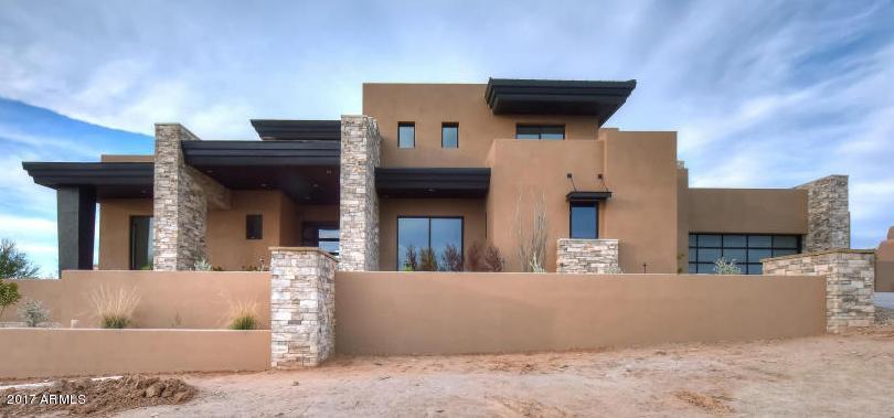 This remarkable NEW custom contemporary estate is underway and nearing completion. Sitting on an acre lot excellent views of the Mcdowell Mountains, Troon, Pinnacle Peak, and downtown Phx. This Contemporary Masterpiece will truly be a One of Kind property with North/South exposure. The home will boast high end finishes with approx. 6,300 sq.ft. of living space that includes 5 bedrooms, 5.5 bathrooms, entertaining Great Room with pocket doors, spacious master suite, modern kitchen with open family room. Backyard has a beautiful infinity pool,large covered deck, sunken conversation deck with BBQ, TV, two-way fireplace and large grassy play area. Oversized 4 Car Garage. *****See Doc Section for Floorplan*** There is so much to do within the highly desirable Community of DC Ranch. Join the private golf club at The Country Club at DC Ranch with its beautiful golf course, tennis facilities, fitness room and gorgeous clubhouse or walk to Market Street to enjoy fine dining and boutique shopping.

The Desert Camp Community Center has an adventure playground, volleyball, lighted tennis courts, fitness room with locker rooms, outdoor heated pool and basketball court and is just minutes from this home.

There's still time for your buyer to customize this home and be the first to live in this unique estate in DC Ranch. Easy to show!