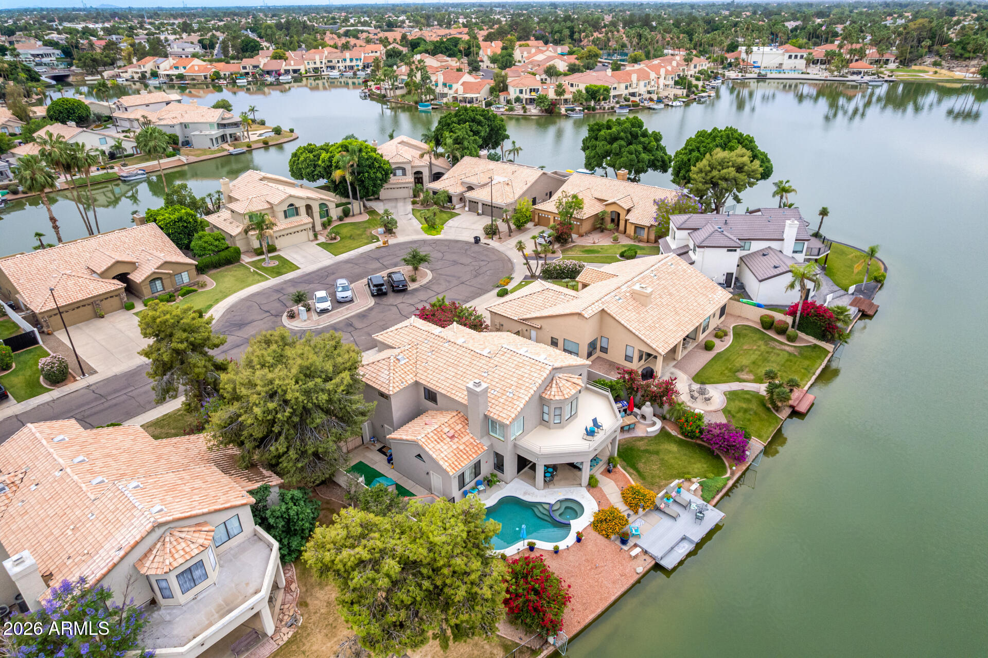 Spectacular WATERFRONT home! Enjoy gorgeous sunset views as you lounge on your large private dock. A bright and fresh interior with updated kitchen and living spaces as well as a full bedroom and bathroom on the main floor and additional bonus room on the second floor.  A luxurious primary suite with private seating area and balcony capturing gorgeous water views
The resort-style backyard includes a saltwater pool, spa,built in grill, private boat dock, and direct big lake access--perfect for boating to the Val Vista Lakes clubhouse, courts, pool and lagoon swim beach. The perfect culdesac location with north/south orientation and waterfront access! This is a special property!