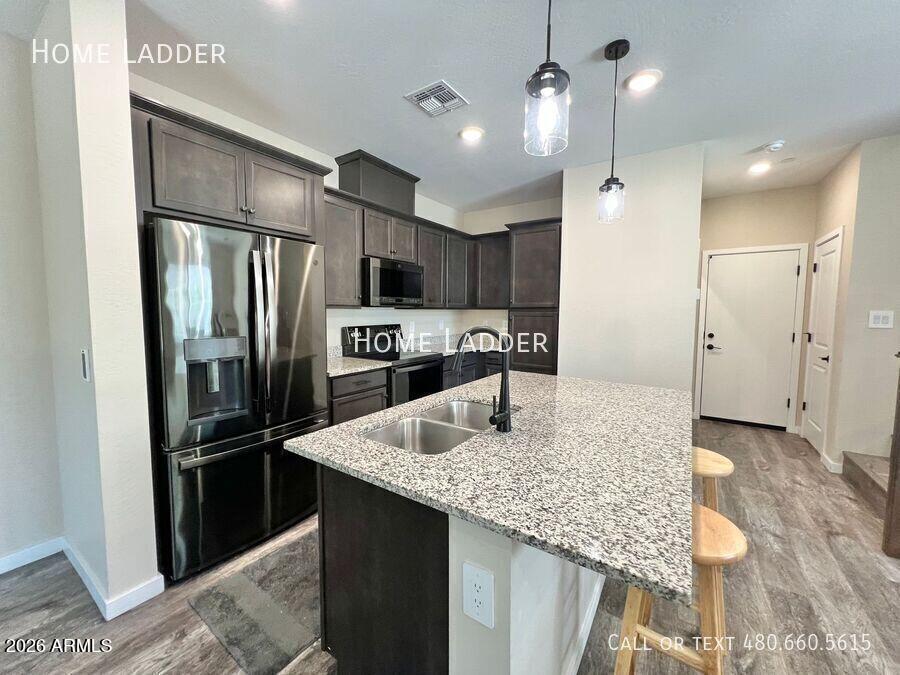 Beautifully upgraded end-unit townhome in the sought-after Mosaic at Layton Lakes community. Built in 2021, this 3-bedroom, 2.5-bath residence offers 1,422 SF of stylish, low-maintenance living with smart home technology including WiFi connectivity and smart lock access. The open-concept floor plan features Luxury Vinyl Plank flooring, abundant natural light, rich wood cabinetry, granite countertops, and a spacious kitchen overlooking the living and dining areas. Upstairs offers a desirable split layout with a private primary suite featuring a walk-in closet, dual executive-height vanities, granite counters, and an upgraded tiled walk-in shower. Loft space, upstairs laundry, and attached 2-car garage add convenience. Enjoy community pool, spa, playgrounds, picnic areas, and walking paths.