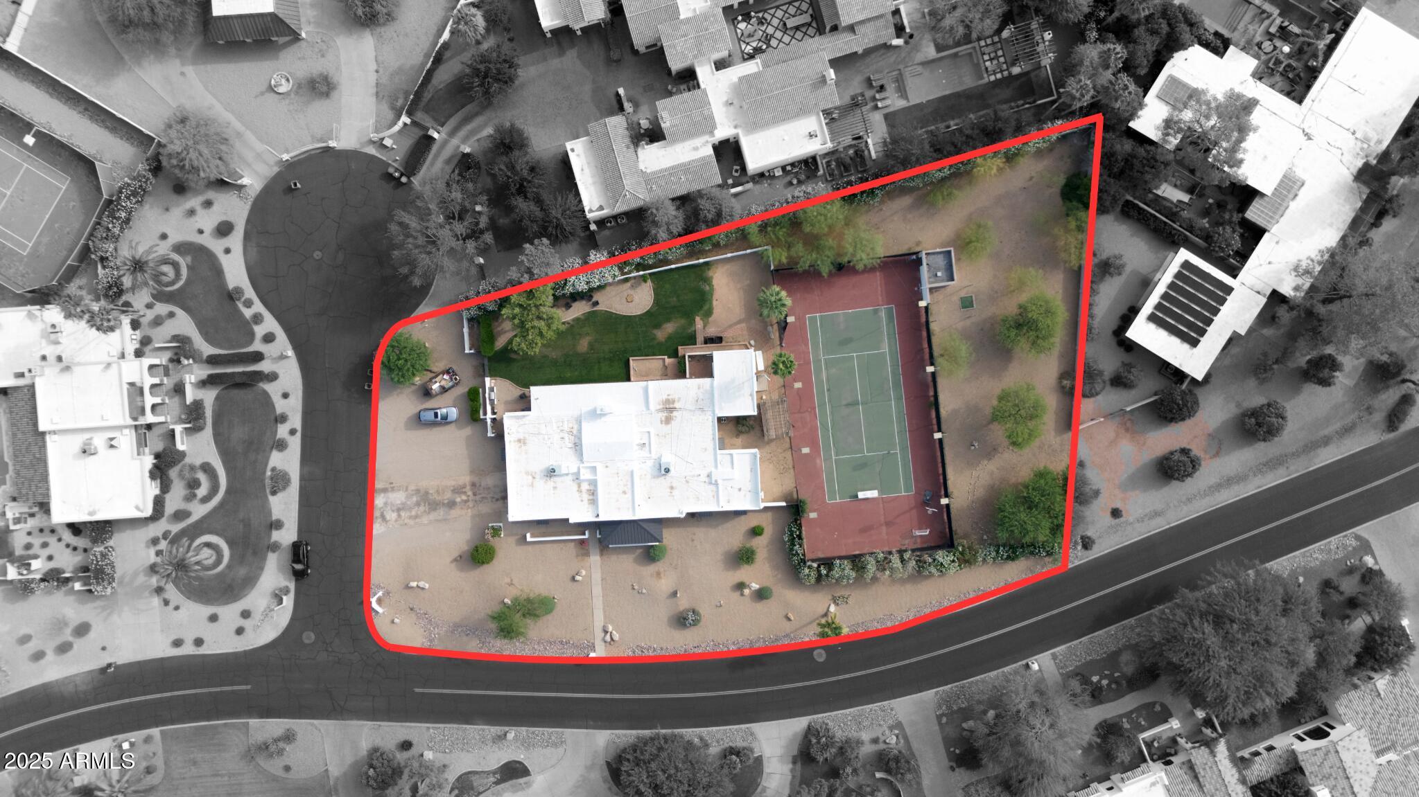 Located in the heart of Paradise Valley, this North/South-facing acre property sits on a quiet street and offers stunning Camelback Mountain views from the backyard. The existing 4,211 sq ft home features 5 bedrooms and 4 bathrooms, including an oversized 375 sq ft guest suite—ideal for a bunk room, office, or media space. The home also includes a large attached bonus room/storage that could be converted to a attached casita - plumbing already in place. Ample outdoor space to create an amazing outdoor experience. Existing tennis court is a full size doubles court measuring 120ft x 60ft.

Recent updates to all secondary bathrooms, beautiful vaulted ceilings in the family room, and newer roof and HVAC systems make this a great option for someone looking for a clean, livable home with the opportunity to update and improve over time. For those looking to build or develop, conceptual plans available for a 7,500+ sq ft estate with a detached 2-bedroom casitaoffering significant upside for an investor or end-user seeking to create a larger custom estate.