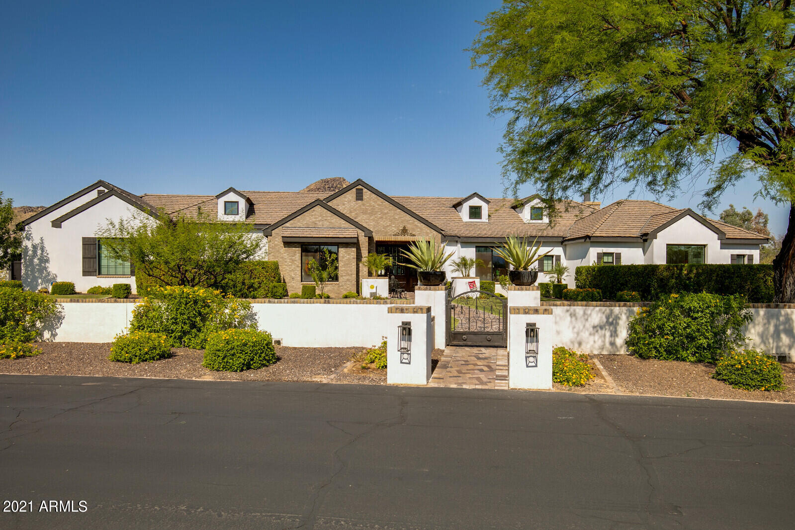 HUGE PRICE REDUCTION!!!  In the heart of Paradise Valley, tucked into a private cul-de-sac sits an exqusite property with breathtaking Mummy Mountain views. Understated elegance & subtle modernity seamlessly mix in this refined split floor plan filled w/natural light & spectacular views from every window.  The living room has multi-sliders which make for a true indoor-outdoor living experience. Have a feast in the delightful dining room w/exposed beam ceiling. Entertain in the fabulous family room complete w/fireplace & unobstructed Mtn. views. Wet bar has an ice maker & a 100 bottle Sub-Zero wine fridge. A true gourmet kitchen offers large wood cabinets w/crown moulding, Quartz counters, multiple breakfast bars, tile backsplash, a huge center island, & cutting-edge appliances including a 6 burner gas stove with griddle & two Sub-zero refrigerators. Home is equiped with a Crestron Home Automation system.  Romantic & sophisticated primary retreat enjoys a fireplace, two sets of French doors that lead to the backyard, bountiful his and hers walk-in closets with washer and dryer & a luxuriously spacious master bathroom w/freestanding tub, glass-enclosed shower, double vanities, granite counters, & his and hers water closets. Bonus room is ideal for a game room. Three additional en-suite bedrooms with walk-in closets. Let's not forget about the HUGE backyard! Lush lawn, built-in grill, TV setup, eating bar, multiple seating areas with fire features, resort-like pool, relaxing spa, basketball/pickle ball/volleyball court, & panoramic scenery will absolutely leave you in Awe!  Check out the video under the photos tab! Come see it today!