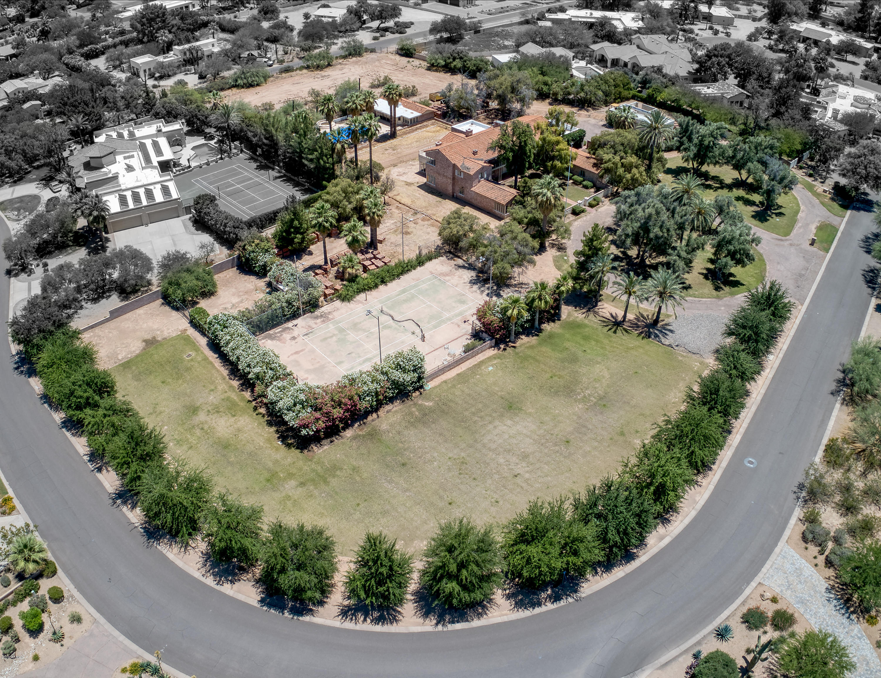 Wow!  Your chance to own 3.77 acres of flat land in Paradise Valley with unlimited options. A slice of heaven, one of the oldest homes still in existence in Paradise Valley....This 1937 charmer still stands on the property, featuring a guest house and tennis court. Your golden opportunity to keep the property as a compound or you have the ability to divide it into 3 separate parcels. Water Well on property for all the irrigation, which is a huge savings for the buyer. Do not miss out on this unique and RARE opportunity!