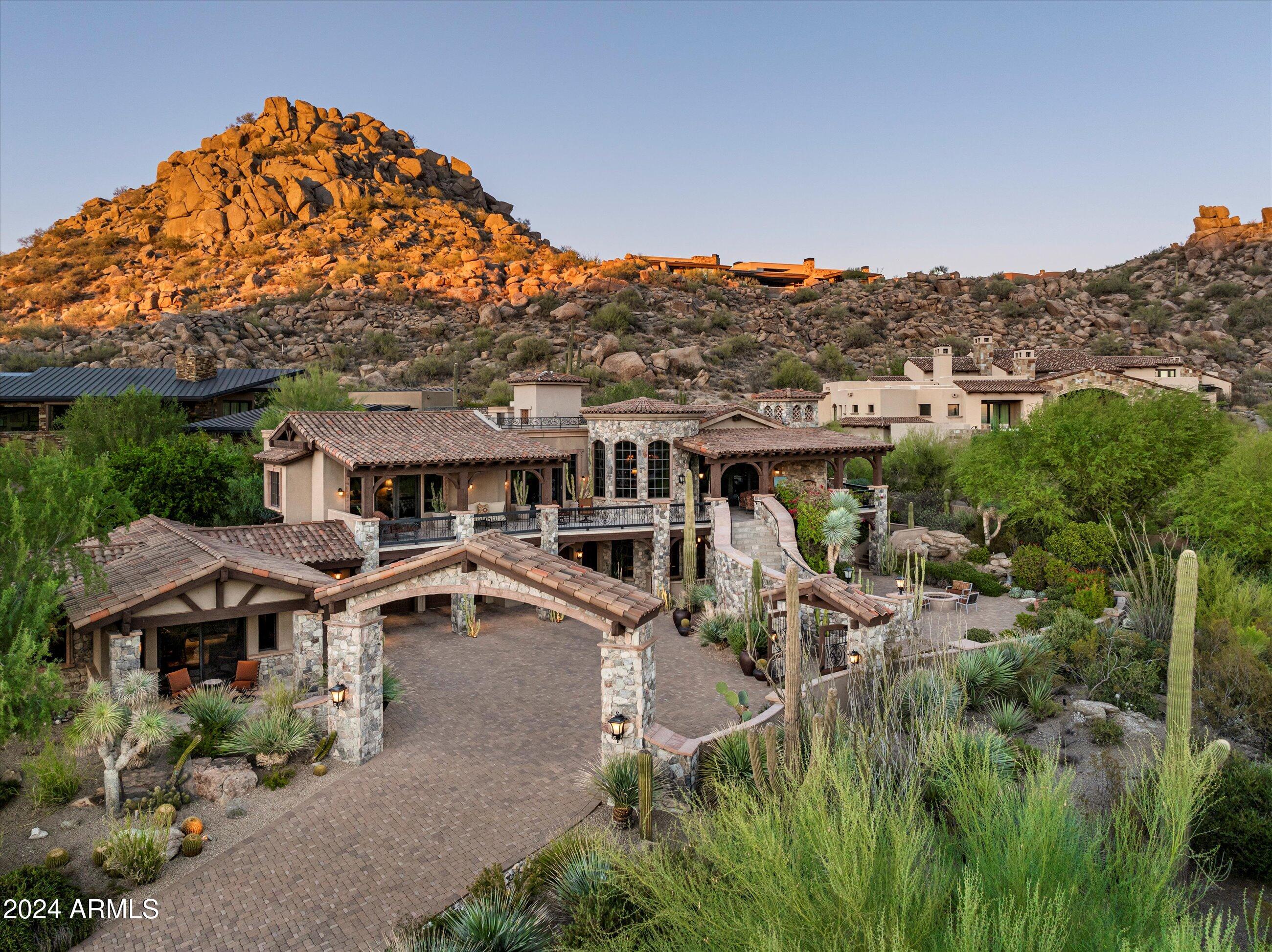 Old world Mediterranean design in the guard-gated community of Estancia * Located on a .75 acre site with commanding views of Pinnacle Peak, Troon Mountain and the McDowell Mountain Preserve * Timeless architecture coupled with a modern floor plan and exceptional finishes create an impeccable residence * The home lives on the main level with the Chef's kitchen opening to the Great Room (wet bar, dining and living room); the Primary suite and owner's den share a view deck offering incredible views * A grand staircase or elevator provide access to the lower level, which is complete with a full guest suite, temperature-controlled wine cellar & dining/tasting room, and a media room * Detached Guest House with sitting room, kitchenette and full suite * Oversized 3-car garage and ample storage complete the residence *