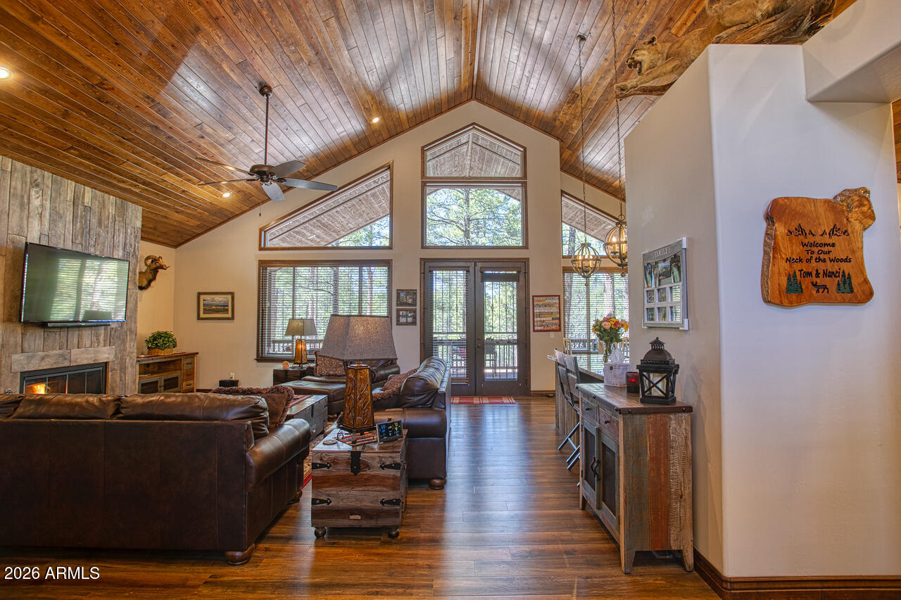 This exceptional luxury home in Arizona's White Mountains is a rare collaboration between premier builders Cambric Construction and Triple R Construction, offering quality craftsmanship and thoughtful design throughout.
Located on approximately 0.91 acres in the private, gated Torreon community of Show Low, the property backs to the Sitgreaves National Forest, providing unmatched privacy and scenic surroundings.
The main home/casita features approximately 3,467 square feet of living space, with expansive front and back decks ideal for relaxing or entertaining. A six-person heated Jacuzzi spa sits just off the primary suite, creating a private retreat.
A fully furnished detached casita includes a full kitchen and bathroom, perfect for guests or extended family. The property also offers flexible garage space for up to six vehicles, or four vehicles plus a fully enclosed workshop. Both the garage and workshop include half bathrooms.
Outdoor features include a paver driveway, five parking spaces, and a walkway leading to a spacious 25' x 25' seating area with a raised fire pit, perfect for gathering and enjoying the mountain setting.
This home features 6 spacious bedrooms, 5 full bathrooms, and 2 half bathrooms, including those in the garage and workshop. The open-concept layout includes a well-appointed kitchen with stainless steel appliances, double ovens, ample cabinetry, a wine cooler, and a dedicated wine bar. Each room is comfortably furnished with inviting mountain-style décor.
Located within the gated Trailhead community, the home sits approximately one mile from the entrance on a quiet cul-de-sac. At its center is a large, wooded island owned by the HOA, ensuring it will remain unbuildable and preserving the home's sense of space and privacy.
The property is being sold fully furnished, both inside and out, offering a true turnkey opportunity; just bring your essentials. This home combines comfort, privacy, and warmth in a peaceful mountain setting