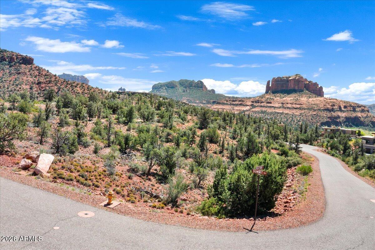 Two adjacent parcels. One rare opportunity. Offered together for the first time, 18 and 38 Peak Point Court represent 1.71 acres of prime buildable land within Mystic Heights, Sedona's most exclusive gated enclave. Perched above Oak Creek with direct sight lines to Cathedral Rock, these lots deliver the panoramic red rock views that define the Sedona experience. Underground utilities run to each lot line. The setting offers a seclusion few addresses in Arizona can match, yet West Sedona is minutes away. Acquire both parcels and build generational Sedona real estate. Close proximity to creek access and hiking trails. This is a truly special opportunity that only one buyer will get to take advantage of. Come see for yourself.