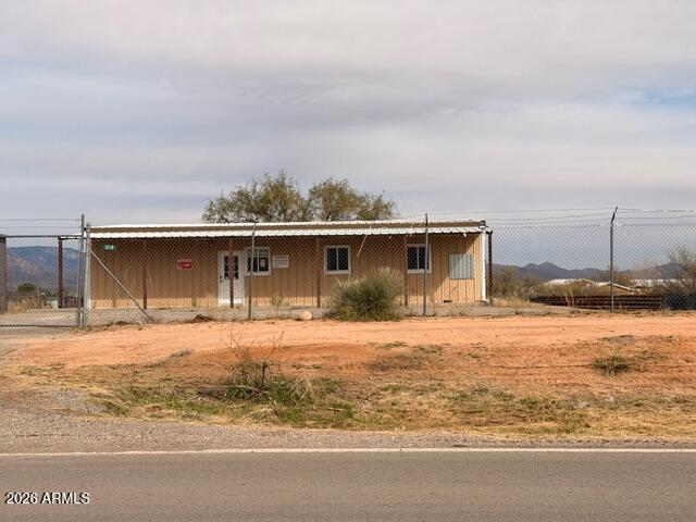 Prime Commercial Opportunity with I-10 Exposure!   Conveniently located just off I-10 at the J-6/Mescal exit, this property offers outstanding visibility and easy access via a paved frontage road (Meadowlark). The 1,482 sq. ft. metal building sits on 0.80 acres and is fenced with chain-link and razor wire for added security on frontage rd. . East and north fence are wood.   The site features paved parking and General Business zoning in rural Cochise County, making it ideal for a wide range of uses. High-traffic I-10 frontage in the J-6 Mescal area provides excellent exposure—perfect for a feed store, small equipment repair shop, or other commercial ventures.  One of the owners is a licensed real estate agent in AZ.