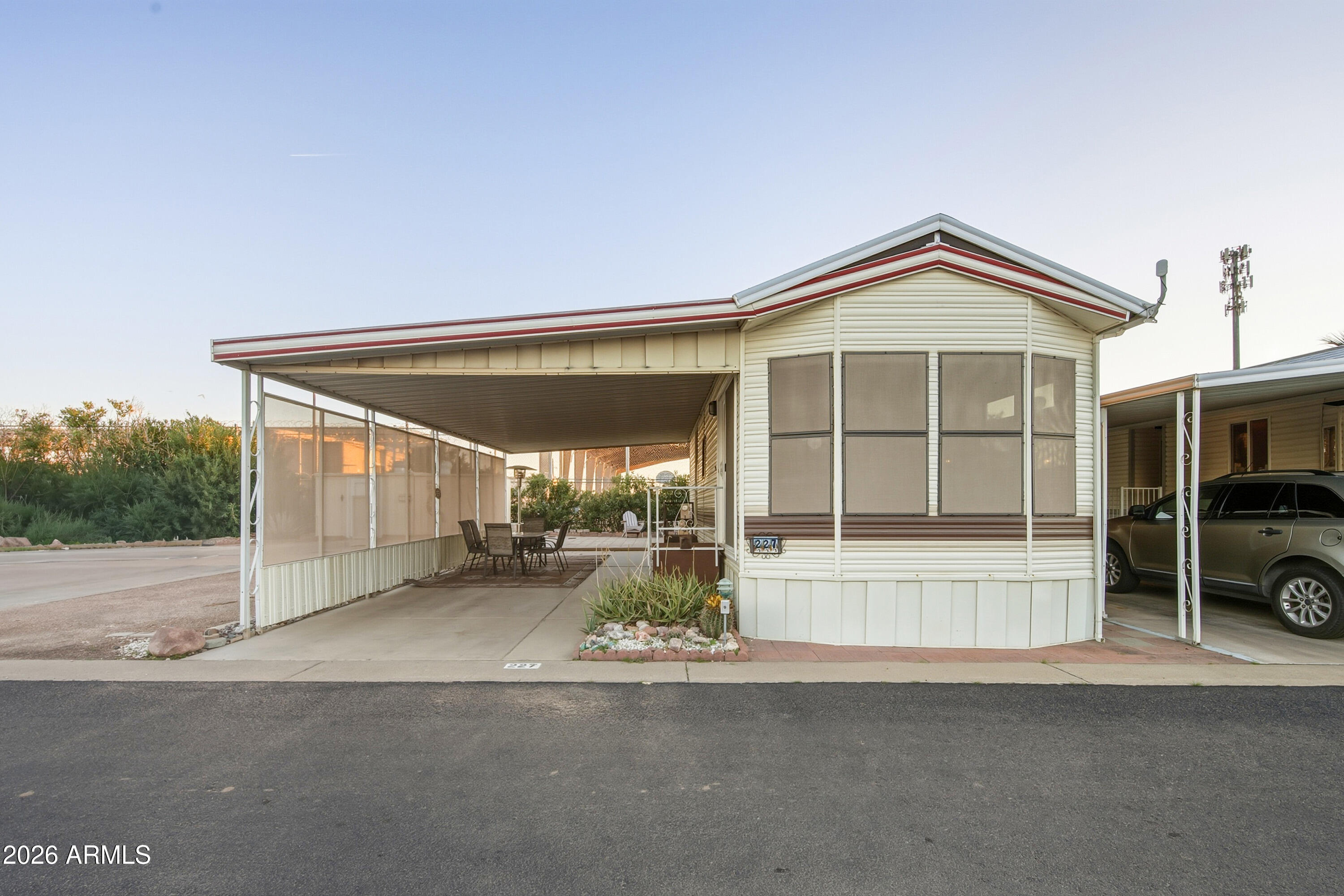 Located on a desirable corner in the 55+ Caliente Casa de Sol community, this fully furnished 1990 park model offers 385 square feet of clean, comfortable living w/land ownership-no lot rent. Home includes a private back patio w/patio furniture and patio heater. It backs up to Homeland Security, which allows for a larger, more open patio space w/added privacy. Adjacent Lot is an undeveloped lot that includes two storage sheds. Lots are not married, offering long-term flexibility & added value. Inside, home is move-in ready w/wood laminate flooring, fresh paint, & excellent built-in storage. The kitchen features a skylight, built-in microwave, garbage disposal, & refrigerator. The full bathroom includes a shower/tub combo, & the layout makes smart use of space & natural light. Residents enjoy access to multiple pools & spas, fitness room, pickleball & shuffleboard courts, hobby rooms, library, & clubhouse with many activities. Three Parks Fairways Golf Course is just minutes away, offering a nearby option for golf enthusiasts.  Whether you're a snowbird, full-time resident, or local professional, this low-maintenance property offers practical living in a welcoming and amenity-rich Florence community.