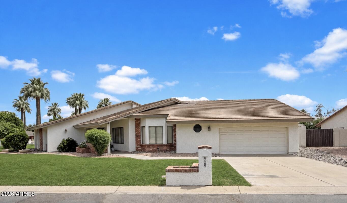 Welcome to one of Litchfield Park's hidden gems! Nestled on the iconic tree-lined Old Litchfield Rd where towering palms and charming streets feel straight out of a storybook. Situated on a massive corner cul-de-sac lot just moments from The Wigwam Golf Club, dining and local favorites, this home is packed with character you simply can't recreate. Inside you'll find warm wood floors, soaring ceilings, skylights pouring in natural light, a stunning wood-burning fireplace, split floorplan and a one-of-a-kind interior atrium centerpiece. The oversized primary suite features a spa-like soaking tub, while outside your private diving pool and expansive backyard create the ultimate Arizona retreat. Charm, warmth, location, and personality... all in one unforgettable home.