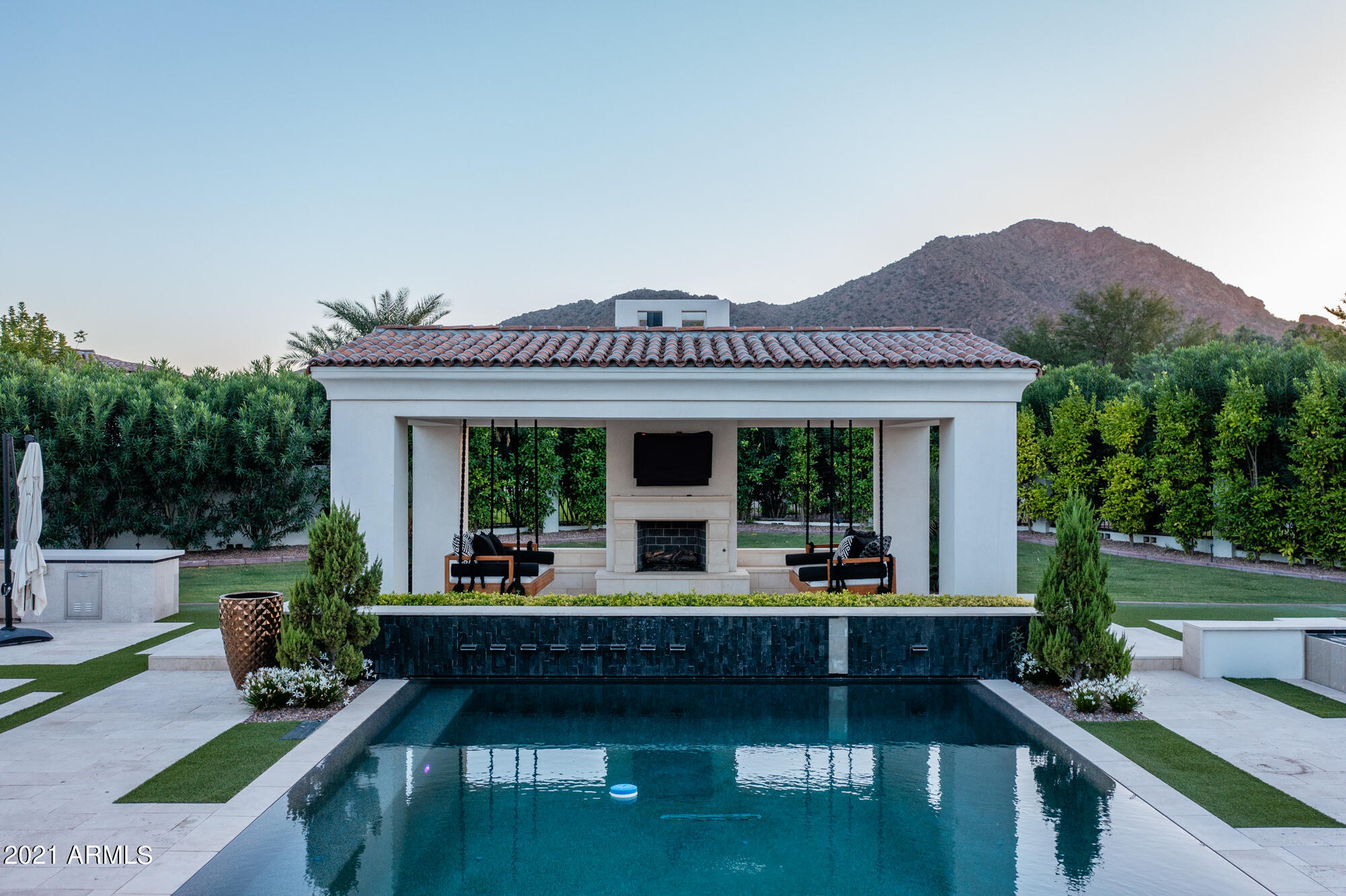 Jaw-dropping views of Camelback/Praying Munk & Mummy Mountain! Hand Finished Russian White Oak Wood Floors! Chef's kitchen complete with Wolf 6 burner gas cook top, Sub-Zero fridge, and a built-in espresso maker. Imported marble kitchen island counter tops as well as a Butler's Pantry! Lux Gold Brizo plumbing fixtures, Sierra Pacific Wood Clad doors & windows! Stunning wet bar w/ 100 bottle Sub-Zero wine chiller. Resort-style backyard w/ Modern Wet Edge Pool, elevated spa, ramada w/ fireplace, outdoor kitchen & turf. Privately Gated w/ courtyard & lighted date palms. Owner's suite features cast iron tub, custom his/her closets, fitness room & brick pattern marble floors! Oversized guest casita w/ private garage!
