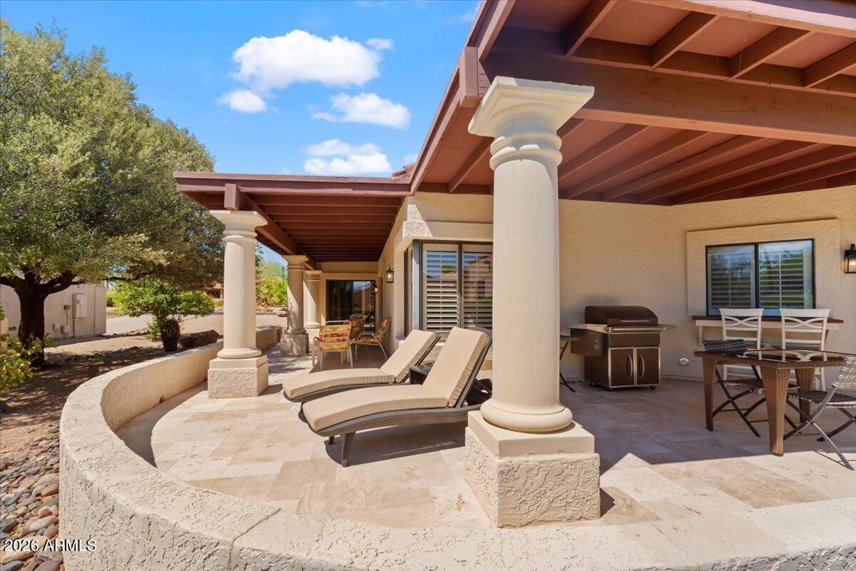 Beautiful N/S exposure 3 bed, 2 bath home on a desirable corner lot in the far east section of the Rio Verde Country Club community. Spacious single-level w/ vaulted ceilings, abundant natural light, wood & tile flooring, upgraded features & lighting, interior shutters throughout & stone fireplace. Unique large covered wrap-around patio surrounded by mature landscaping. Eat in kitchen w/ patio view & access, upgraded cabinetry, SS appliances, recessed lighting & next to formal dining. Remodeled full hall bath & generous fully remodeled primary suite w/ patio view & access, dual vanities, walk-in shower & closet. Enjoy year-round golf, pickleball, tennis, fitness center, heated pool & spa, clubhouse dining & activities in this premier 55+ community. Perfect for homeowner or rental investor!