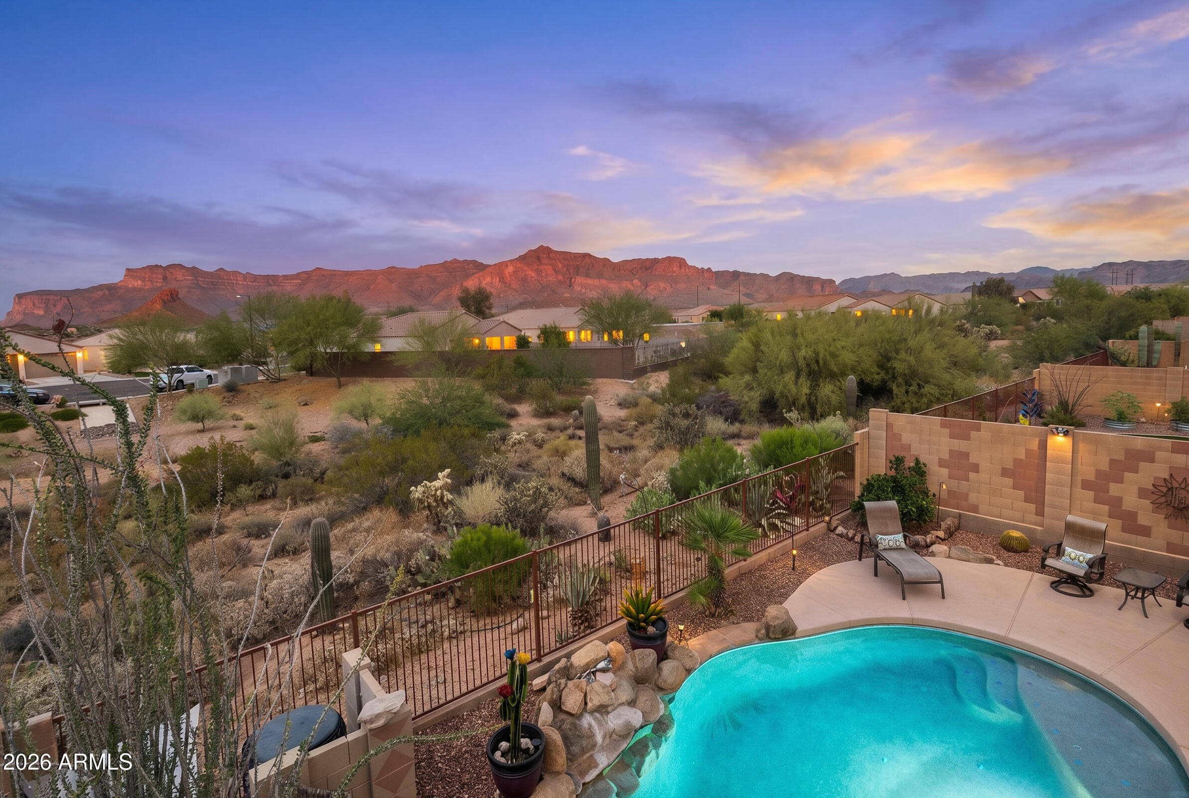 Enjoy year round relaxation and tranquility in your SALTWATER  Pool (heating/cooling 2022) surrounded by Gorgeous Mtn Views and the privacy of a desert wash behind. 
A secluded COURTYARD sets the tone for intimate gatherings. Upon entering, you're welcomed by an open floor plan with light-filled spaces and dramatic MTN VIEWS from the great room, kitchen, and dining room framed by wood shutters throughout.
The spacious kitchen features updated cabinets, GRANITE counters, PANTRY & large peninsula perfect for hosting,  Wake up to sweeping Mtn Views in your spacious primary bedroom. Guests will appreciate the secluded guest bedroom and resort style tiled shower with dual shower heads.
A rare 3-CAR GARAGE, new AC (2023), H2O Heater (2024) and an extended paver driveway complete the package. Enjoy access to the fitness center, clubhouse &  heated pool. Garbage collection is also included as part of your lHOA. Explore the best the Superstitions have to offer, incredible hiking, off road trails, championship golf courses, locally owned restaurants only 45 minutes from Sky Harbor airport and 20min to Mesa Gateway airport.