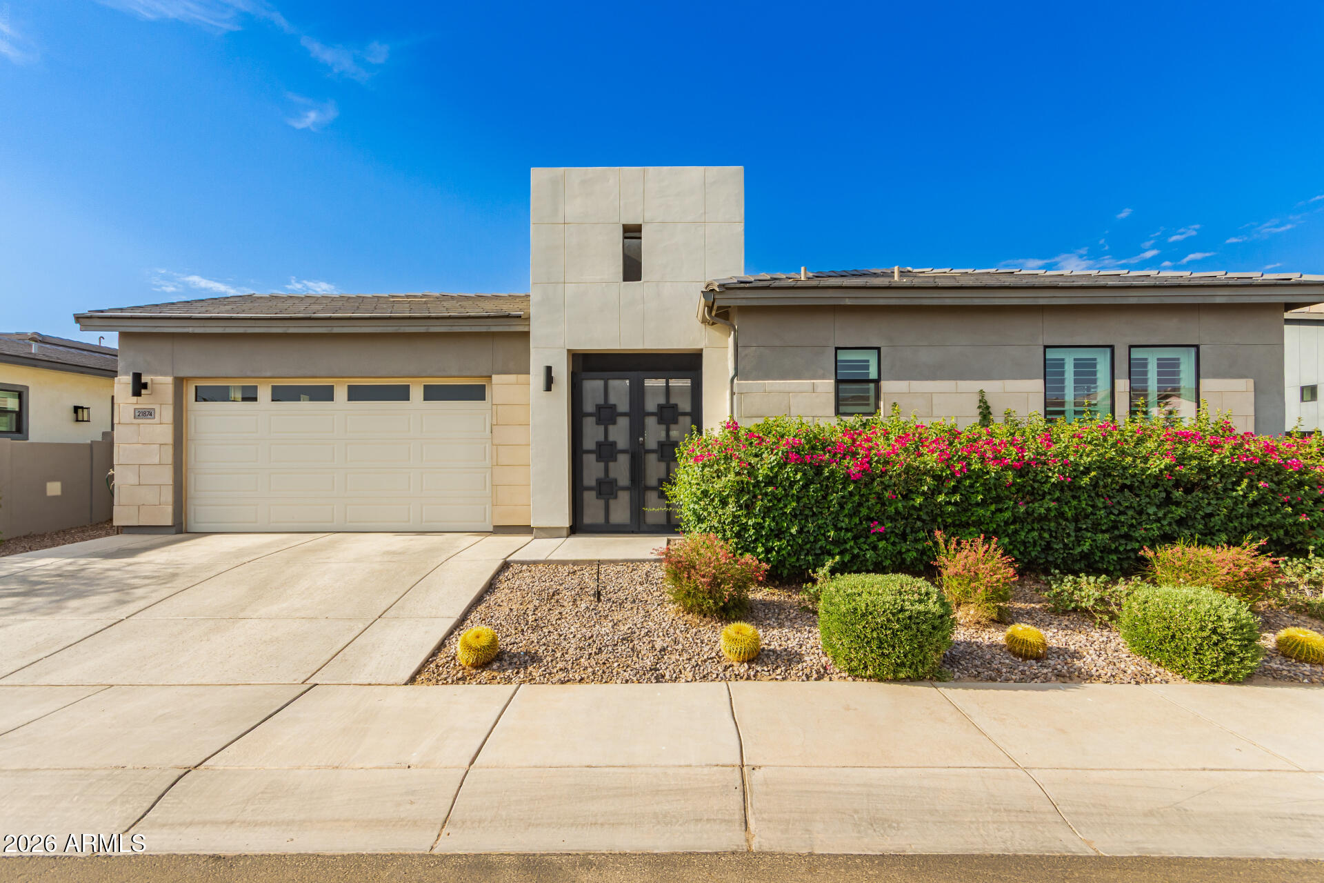 Welcome to 21874 E Via De Arboles, a luxurious 3,196 sq ft single-family home built in 2021, nestled in the prestigious gated community of Caleda by Toll Brothers, one of Queen Creek's most desirable neighborhoods. This beautifully designed residence offers 4 spacious bedrooms, 4.5 bathrooms, and 2 versatile bonus rooms that provide unmatched flexibility for your lifestyle. One of the bonus rooms includes its own private sliding side entrance, perfect for use as a home office, guest suite, or creative studio. The primary bedroom and two additional bedrooms have private en suite bathroom, ideal for guests or multi-generational living. The open-concept layout blends modern elegance with comfort. At the heart of the home is a chef's kitchen featuring premium appliances, extended cabinetry, a large island, and designer finishes flowing seamlessly into the generous living and dining areas. Enjoy cozy evenings around the custom fireplace and mantel, and entertain with ease in this thoughtfully designed space filled with natural light.

Step outside to your private backyard retreat, complete with a large sparkling pool, professionally landscaped grounds, and a peaceful greenbelt directly behind the home for added privacy and scenic charm. The breathtaking mountain views create the perfect backdrop for relaxing evenings and weekend gatherings.

Located in Queen Creek, this home is just minutes from top local amenities and Combs High School. It offers convenient access to the Queen Creek Olive Mill, Schnepf Farms, and San Tan Mountain Regional Park. Blending modern luxury with welcoming community charm, this home truly stands out. A professionally mounted Tesla charger in the garage adds convenience and value.