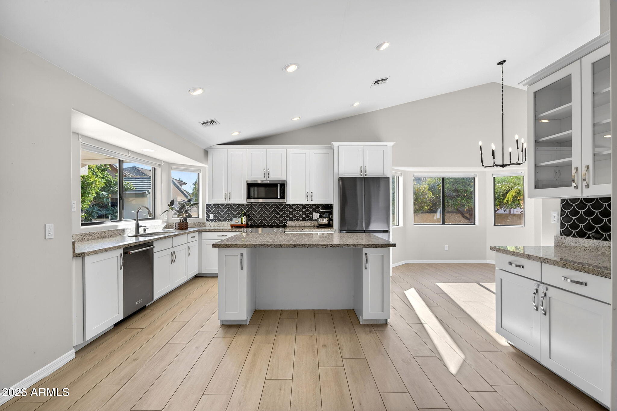 Beautifully updated single level home with No HOA in North Mesa!  Completely remodeled in 2017.  Primary bathroom remodeled this year.  Spacious master suite features fireplace, large sitting room, double sink vanity, walk-in closet, free standing tub and separate shower with gorgeous tile. Kitchen has plenty of storage, island, and additional recessed lighting.  Cozy wood look tile in the main living area and bathrooms. Out back features a MASSIVE covered patio with built-in barbecue. Detached air conditioned and insulated building that can be a guest house, office, or gym. Roof done in 2018. How about your own 18 fruit trees?!!! East side has a double gate with slab for boat or camper.  West side has a large play area.  Cap it off with a 3 car garage and this is a true North Mesa gem!