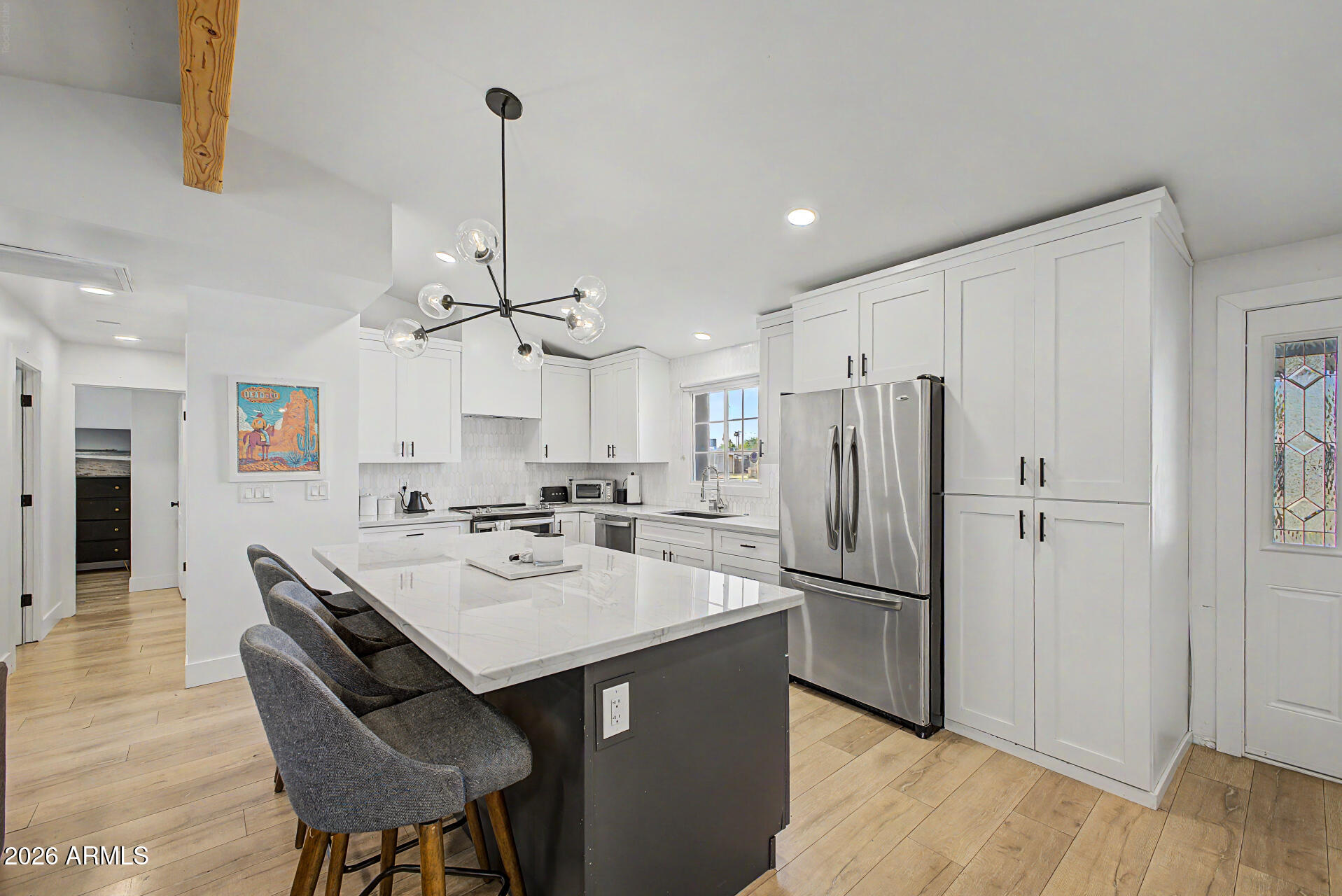 Welcome to this charming single-level residence on a peaceful cul-de-sac! Discover an inviting open layout with vaulted ceilings, exposed beams, recessed lighting, and wood-look flooring. The gourmet kitchen comes with granite counters, crisp white shaker cabinets with crown moulding, a striking tile backsplash, stainless steel appliances, and an island with a breakfast bar. The primary bedroom includes a versatile bonus room, a private bathroom, and a convenient walk-in closet. Unwind at the end of a long day in the backyard, complete with a covered patio, stylish pavers, pristine artificial turf, and a couple of sheds for additional storage. Don't miss out on this incredible gem!