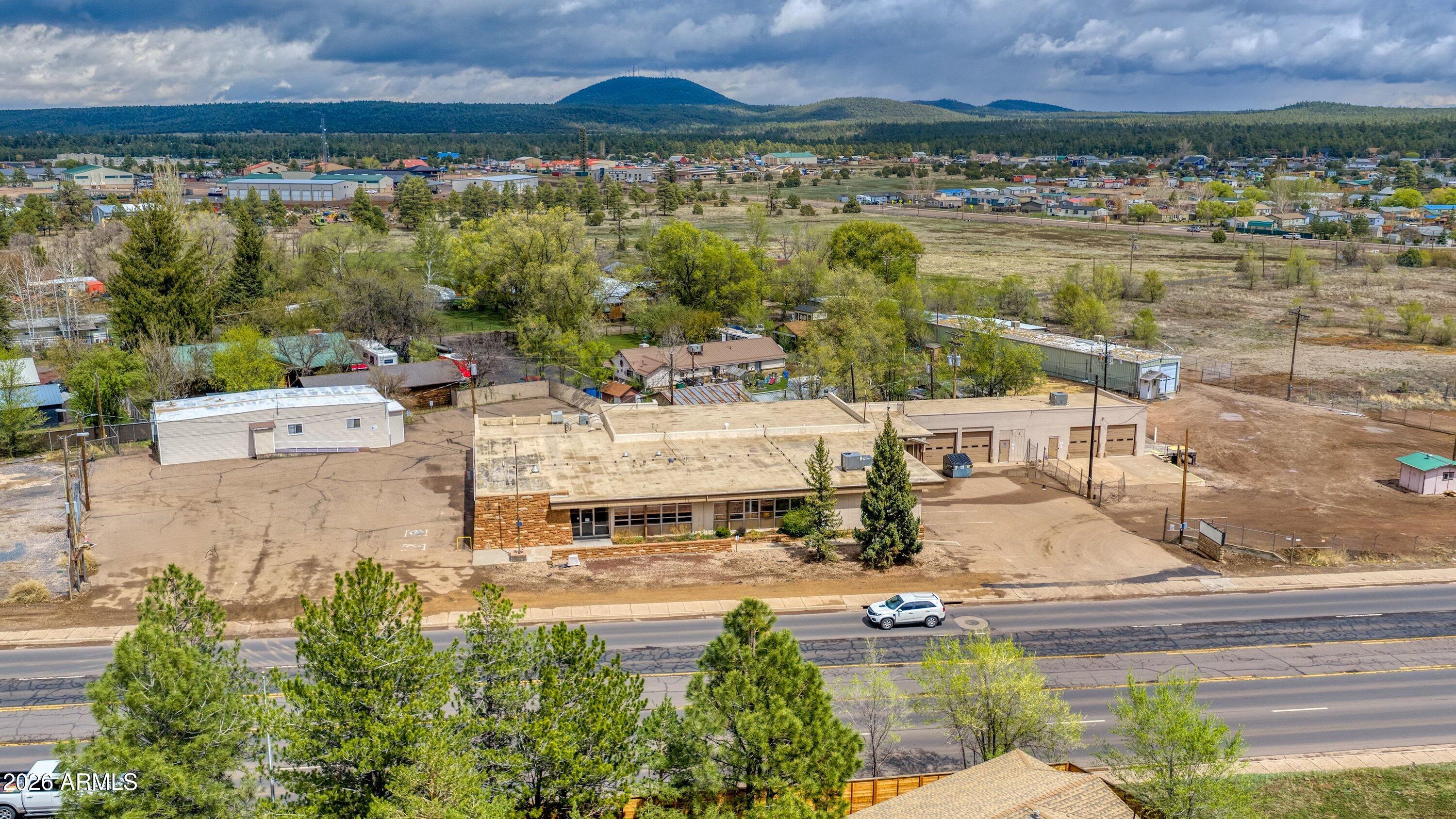 Former Navopache Electric Co. Headquarters | Premium Commercial Property in Pinetop-Lakeside, AZ

Position your business at a highly visible, high-traffic location on White Mountain Blvd (SR-260 corridor)--one of the most recognized commercial arteries in the White Mountains. This Pinetop-Lakeside commercial real estate opportunity combines unmatched frontage exposure, operational infrastructure, and flexible multi-building functionality on 2.46 acres, creating a true turnkey headquarters environment for a growing or established enterprise. From the moment you arrive, the main office building establishes a strong corporate presence. Designed to support a full administrative operation, the interior features a welcoming reception area, multiple private offices, conference rooms, and a dedicated boardroom. Abundant natural light enhances the workspace, creating a professional and productive environment ideal for leadership, client engagement, and team collaboration.

Beyond the front office, the property expands into a fully equipped operational campus--built for efficiency, scalability, and real-world business demands. The secured and fenced yard provides organized space for fleet parking, equipment storage, and material staging, supporting logistics-heavy, service-based, or contractor operations with ease and security.

The shop and service facilities are a major asset, featuring multiple RV-height roll-up bays designed to accommodate large trucks, trailers, and specialized equipment. Whether your operations involve construction, utilities, transportation, or field services, this infrastructure supports seamless daily workflow and high-capacity functionality.

A secondary office building adds exceptional flexibility for expanding teams, satellite departments, or project-based operations. With private offices, meeting areas, and its own amenities, it allows businesses to scale strategically without disrupting core headquarters operations.

Additional warehouse and flexible-use spaces further enhance the property's adaptability, making it suitable for light industrial, distribution, storage, fabrication, contractor services, utility operations, or mixed-use commercial applications. This level of versatility is rarely available in the White Mountain commercial real estate market.

Set up for long-term operational success, this property is more than office space--it is a fully integrated commercial campus designed for organizations that require visibility, infrastructure, and room to grow.

With direct highway frontage, strong signage potential, and immediate access to regional transportation routes, your business benefits from both maximum exposure and operational efficiency in one strategic location.

Opportunities of this scale and functionality in Pinetop-Lakeside are exceptionally rare. This is where companies can establish roots, expand operations, and elevate their presence in the White Mountains.

A true headquarters solution--where location, logistics, and leadership come together.