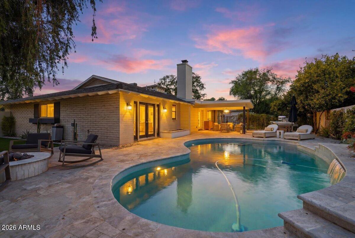 Nestled on an oversized corner lot in one of Central Phoenix's most sought-after neighborhoods, this extensively remodeled ranch-style home combines timeless character, thoughtful updates, and exceptional outdoor living. Mature landscaping, lush greenery, and thoughtfully designed outdoor spaces create a private retreat just minutes from some of the best dining, shopping, and entertainment the city has to offer.


Inside, warm hardwood floors set the stage for a thoughtfully designed interior. Just beyond the entry, a stunning custom bar and lounge area creates an immediate focal point, flowing seamlessly into a spacious dining room and beautifully renovated kitchen featuring custom cabinetry, marble backsplash, and premium finishes throughout. A flexible floor plan offers multiple spaces to gather, relax, and entertain with ease. The spacious primary suite offers direct backyard access, custom closet built-ins, and an updated bath featuring a walk-in shower and timeless tile finishes. Secondary bedrooms are generously sized and complemented by a dedicated office nook, oversized laundry and mudroom, plantation shutters, and thoughtfully integrated storage throughout the home.

Step outside to a backyard designed for Arizona living. The expansive covered patio overlooks a sparkling pool and beautifully maintained grounds, with mature trees and lush landscaping creating a sense of privacy rarely found in Central Phoenix. Whether hosting friends and family or enjoying a quiet evening outdoors, the backyard offers the perfect setting to relax, unwind, and enjoy Arizona's year-round sunshine.

Just moments from Murphy's Bridal Path, top-rated schools, and the best of North Central Phoenix, this is a rare opportunity to own a truly turnkey home in one of the Valley's most established and desirable neighborhoods.
