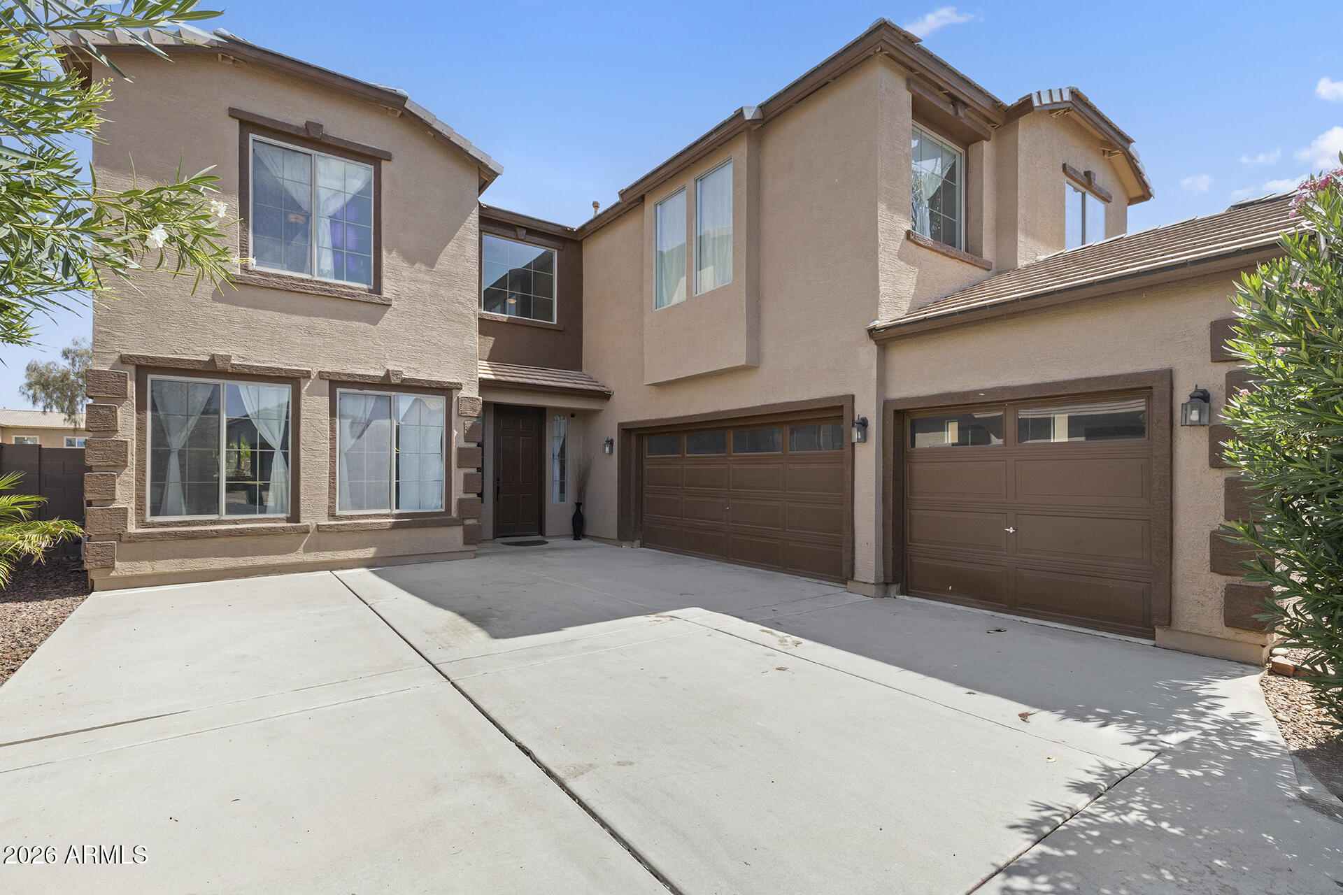 Modern Living in Maricopa! Updated 6 bedroom home with a fresh, contemporary feel featuring a spacious formal living & dining area with soaring ceilings & a statement staircase, accessible from two sides. The open floorplan kitchen showcases white cabinetry, stainless steel appliances, quartz countertops, breakfast bar seating, large pantry & dining area with a sliding glass door for easy indoor/outdoor flow. The connected family room has a fireplace to add warmth. The main level includes a bedroom & nearby half bath, while upstairs offers five generously sized bedrooms, including a huge converted loft-style bedroom with additional space ideal for a game or TV area, its own fireplace & closet. The primary suite is oversized with a private ensuite featuring double vanities, abundant cabinetry, soaking tub, walk-in shower & walk-in closet. The backyard includes a covered patio, turf & desert landscaping ready for customization. A 3-car garage completes the home. Enjoy community amenities including two pools, gym, basketball & tennis courts, playgrounds & splash pads, plus convenient access to shopping, dining, recreation & John Wayne Parkway!