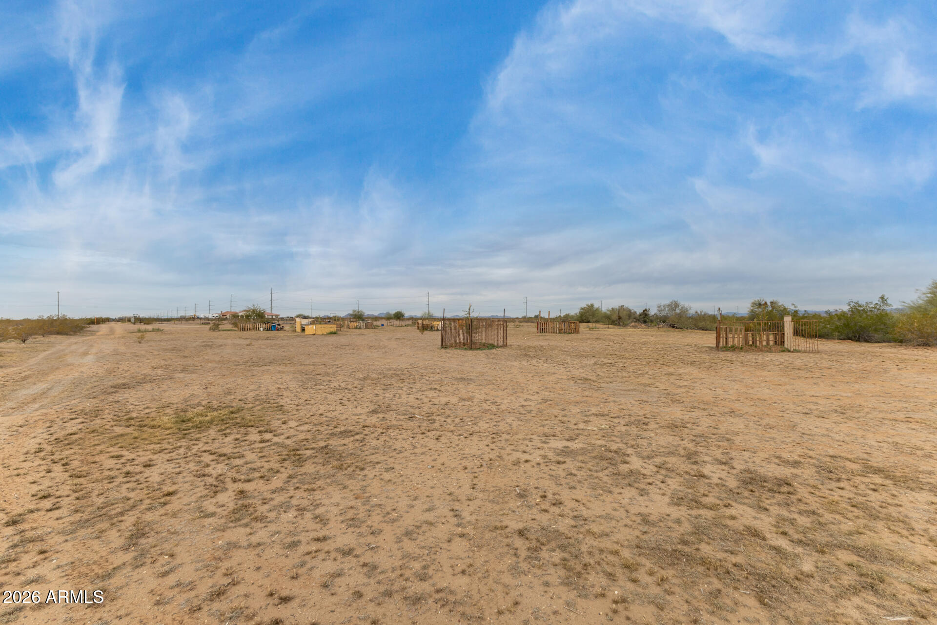 Be the proud owner of this 2-acre vacant lot! Exceptional opportunity to build your custom home in a peaceful setting surrounded by sweeping mountain views. The property is fenced, level, providing a beautiful desert landscape and a blank canvas to design your ideal retreat. Enjoy the convenience of easy freeway access while still feeling tucked away in a serene environment. The lot features a shared well and electricity available nearby. Septic and sewer systems are not currently in place, giving buyers the freedom to plan according to their needs. A rare chance to create a custom home that captures both privacy and breathtaking scenery. Make it yours today!