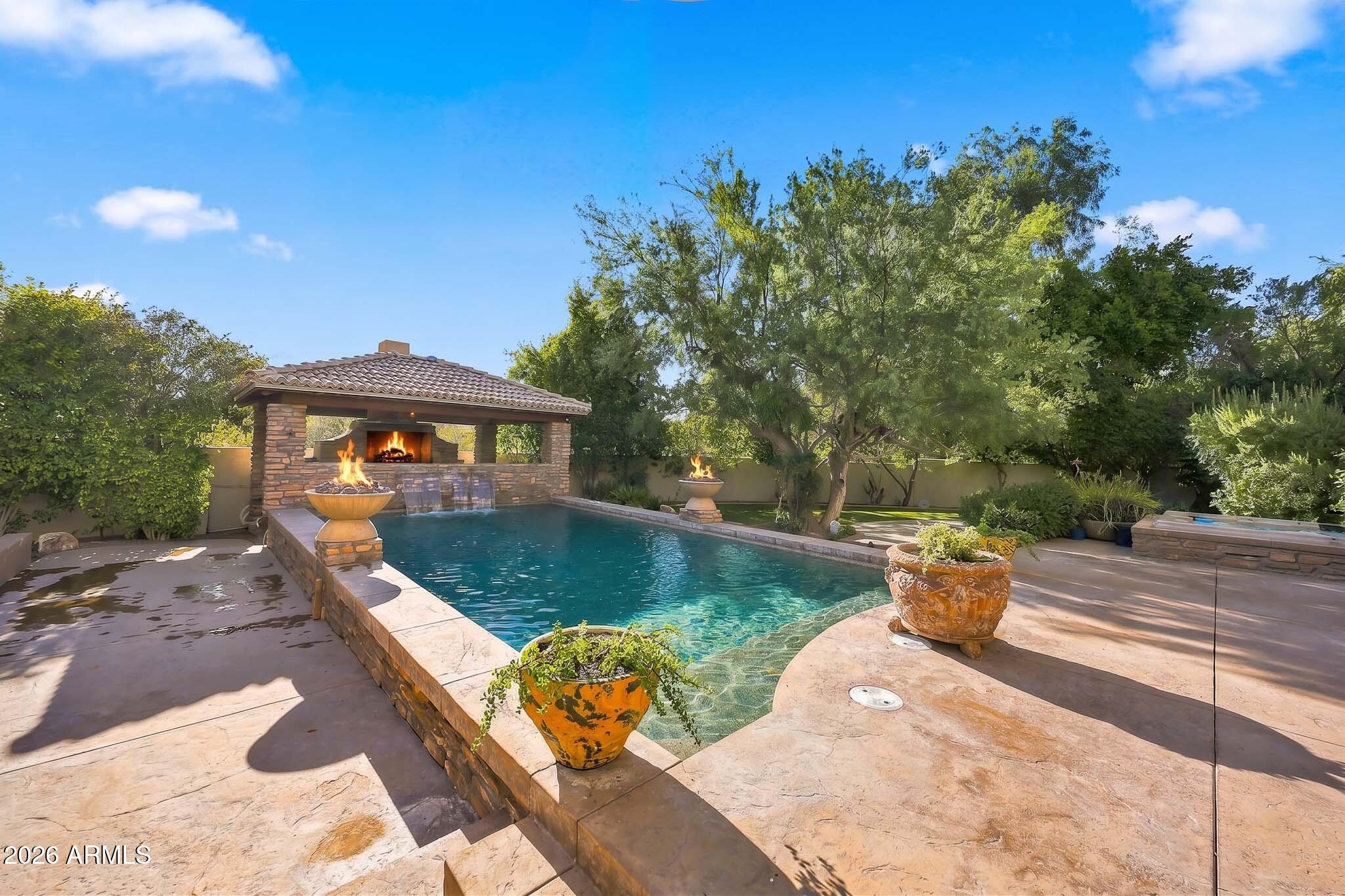Spectacular custom one of a kind, incredibly located no HOA Scottsdale estate with full casita where timeless craftsmanship, artisan details, and breathtaking scenery come together. Arrive to a circular driveway surrounded by mature Sonoran desert landscaping leading to a lush courtyard with a tranquil fountain and ample seating space. Enter into dramatic formal living room showcasing 22-foot coffered ceilings, hand carved fireplace, private office, wet bar with grand architectural radius windows that frame incredible mountain views while filling the home with natural light. Main home features 3 bedrooms with full ensuite bathrooms- split floor plan including large bonus room on primary wing with outdoor access, primary bedroom has dual fireplace, serene seating area with incredible views. The private 485-square-foot guest house is connected by a breezeway and features its own iron door entrance from side yard. Casita offers large living space, kitchenette, full bath, separate HVAC system, water heater, creating endless flexibility for guests, multigenerational living, or a private retreat.

Thoughtfully selected finishes throughout both homes include Bavarian Cherry hardwood floors, Turkish travertine, solid alder doors, custom alder cabinetry, solid cedar exterior doors, and custom glasswork by award-winning Southwest artist Bob Berg. Oversized 3 car garage with built in cabinetry and plenty of room to spare, plus ample paved parking on side yard. 

Designed to embrace Arizona's indoor-outdoor lifestyle, the backyard features a resort-style pool with water and fire features, separate spa, outdoor kitchen, and expansive sunken pergola with a wood-burning fireplace. A custom spiral staircase leads to a reinforced view deck capturing spectacular 360-degree views, unforgettable sunsets, and the surrounding mountain landscape.

Tucked into the scenic beauty of North Scottsdale, this estate offers exceptional privacy, no neighbors behind, premium custom details throughout, and a level of character, craftsmanship, and charm rarely found. Conveniently located just minutes from world-class golf at Troon, expansive hiking trails, Boulders and Four Seasons Resort & Spa, and easy loop 101 access.