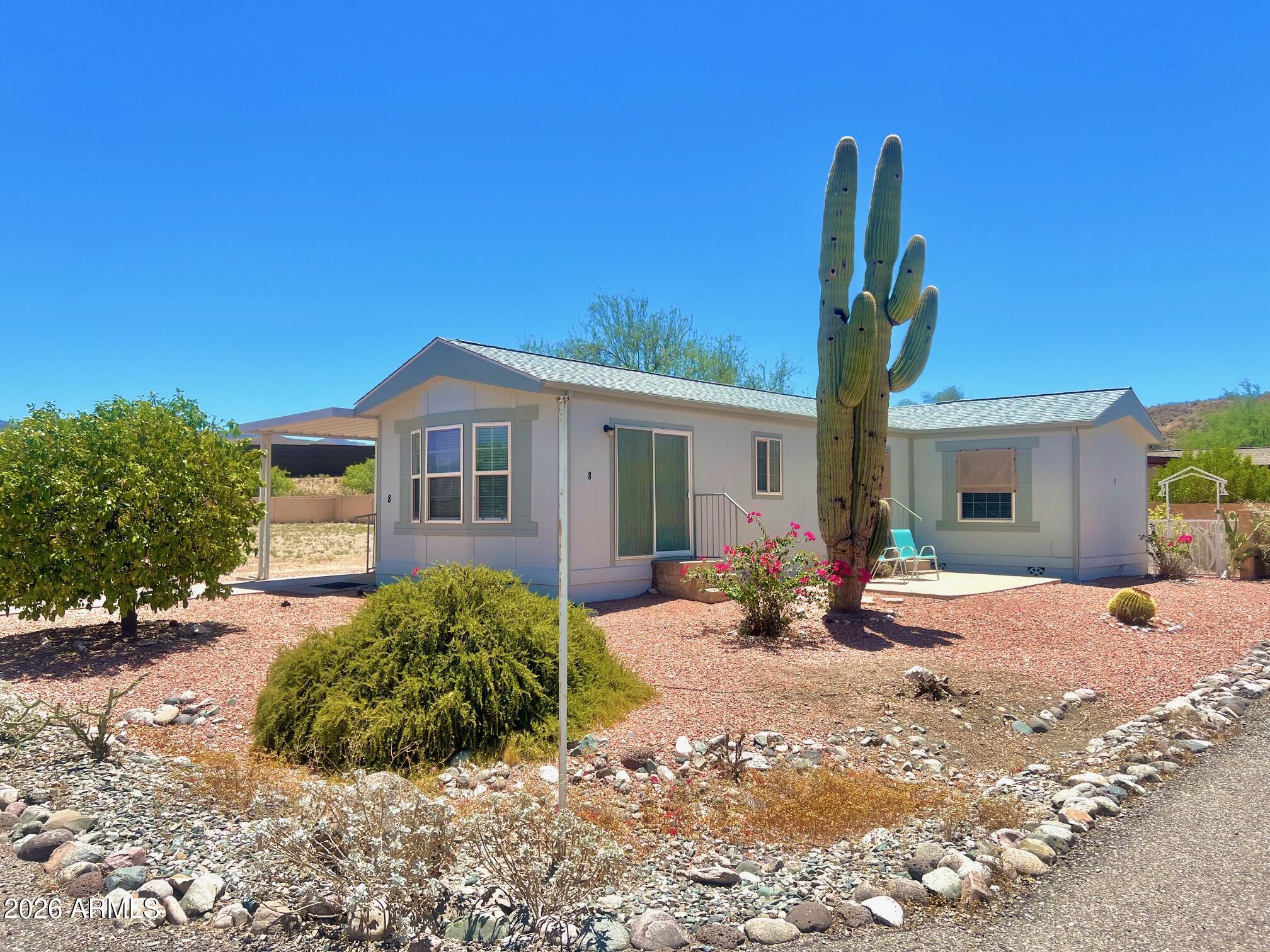 Beautiful home located in a desirable 55+ resort style gated community in Black Canyon City . This home sits on a nice size corner lot with Mountain View's from all sides. This home features two bedrooms/2 bathrooms plus a den area off kitchen. Vaulted ceilings  makes this home very spacious. Covered carport and shed for storage. Two mature grapefruit trees, and one lemon tree produce plenty of fruit. Beautifully maintained park with clubhouse and pool/spa which is included in monthly park lease fee which also includes water, sewer, and trash.