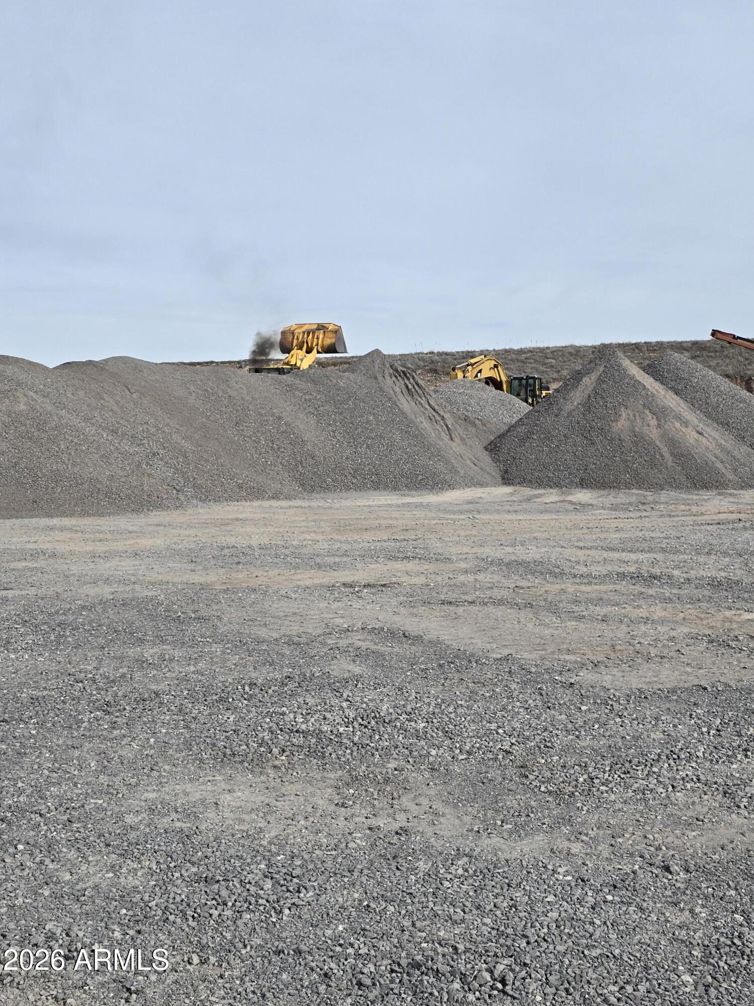 Twp parcels are included in this listing that total 26.64 acres (50313014A and 50313014B). The property sits on a shelf of basalt. These holes have been drilled throughout the site, blasting has been completed and several material piles are on the surface.  Proof of funds to be provided for an approved appt.