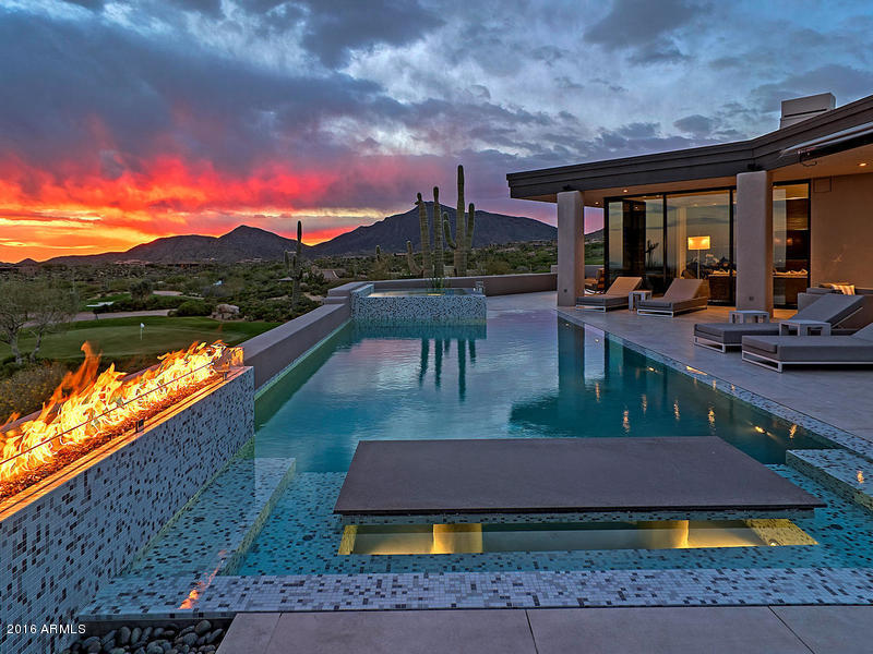 One of a kind sleek hot contemporary with 180 degree views of the valley, sunsets, mountains and Cochise Geronimo driving range.  Featuring walls of glass an open floor plan with den, 2 sumptuous guest-suites, guest casita and private master suite with stunning marble bath.  The finest of finishes have been used throughout, 4 fireplaces, wrap around patio with amazing outdoor kitchen, TV and fire pit, Savant system, security cameras, air conditioned garage and so much more. Desert Mountain membership not included but available from club upon approval.