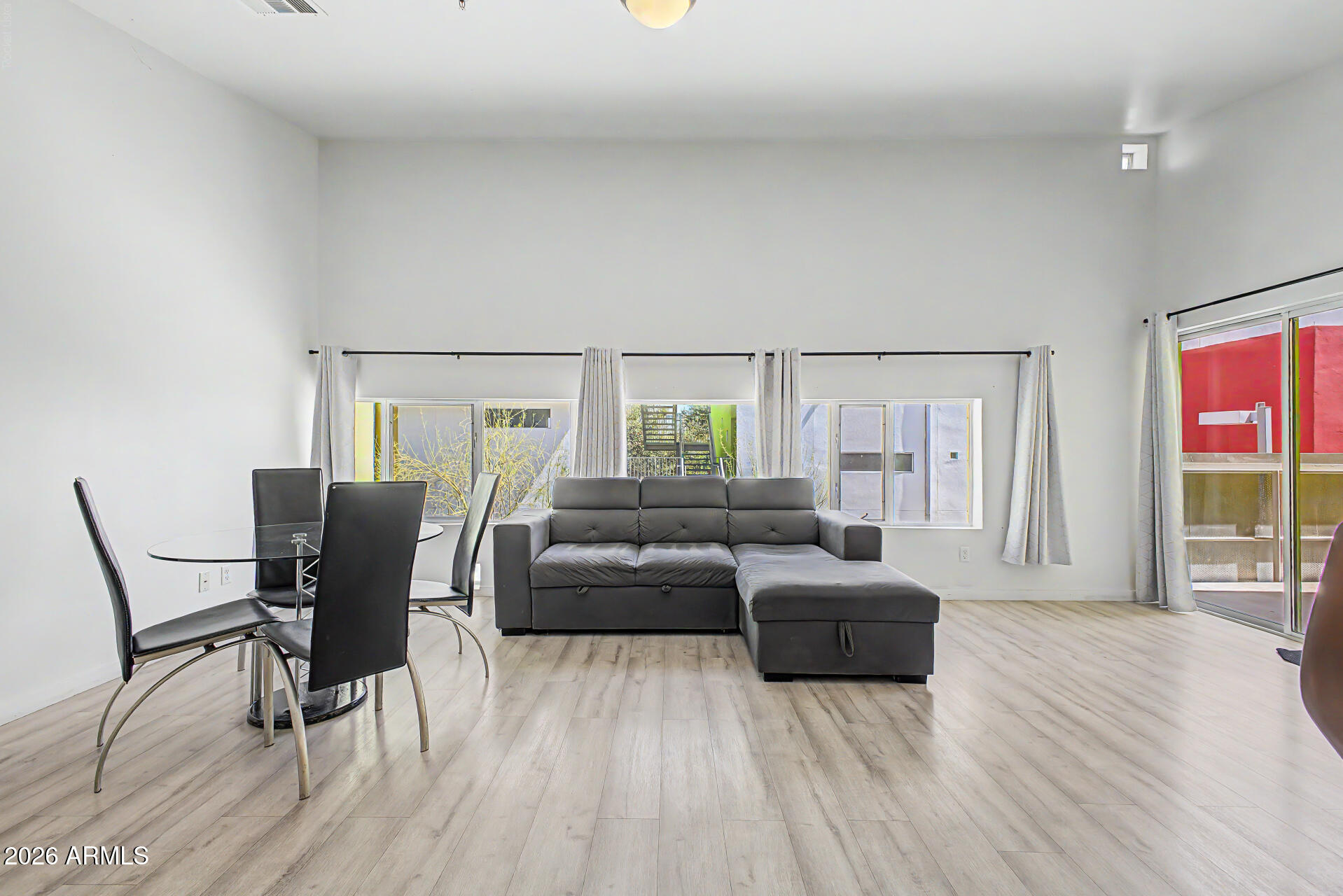 This apartment unit in Vale Condominiums offers both convenience and comfort! You'll be delighted by the spacious open layout with vaulted ceilings, a soothing palette, and attractive wood-look flooring. The well-appointed kitchen boasts flat-panel wood cabinetry, chic pendant lighting, stainless steel appliances, a pantry, and a two-tier peninsula with a breakfast bar for quick meals or entertaining.The cozy bedroom includes a walk-in closet and private bathroom for added comfort. Unwind on the charming balcony, perfect for enjoying a good book or refreshing drinks. Moments from ASU, this inviting condo blends comfort and convenience, creating a welcoming space to live, learn, and recharge. Don't miss your chance to own this one!