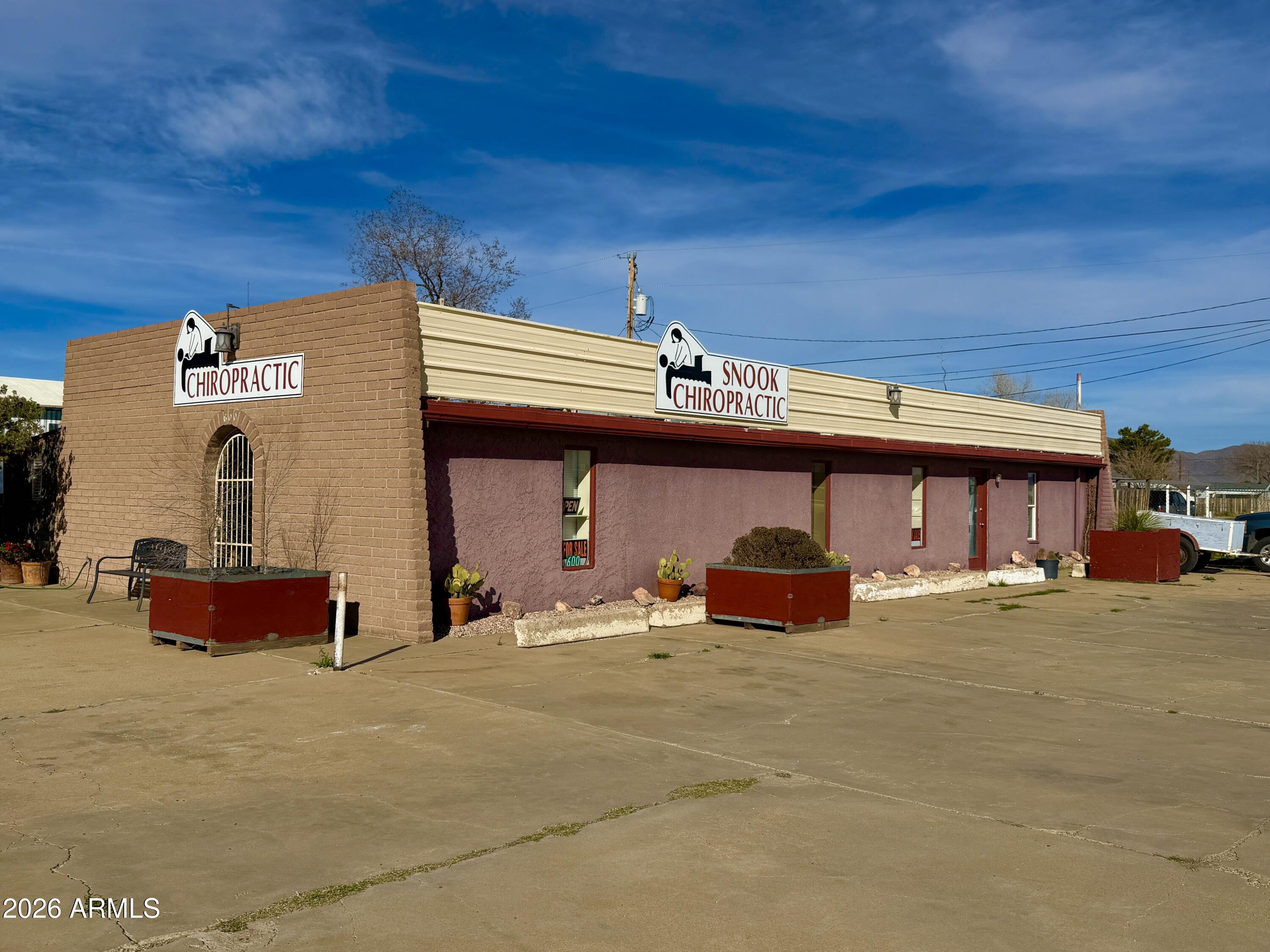 INCREDIBLE LOCATION! High-traffic, high-visibility commercial corner lot in a prime Uptown corridor on Rex Allen Dr, just three blocks from the hospital and surrounding medical facilities. This well-maintained building is currently operating as a chiropractic office and offers excellent flexibility for a variety of professional uses. 
The property features a minimum of 10 on-site parking spaces, providing convenience for clients and staff. Its strong street presence and corner positioning offer outstanding exposure and signage opportunities. Ideal for continued chiropractic use or conversion to medical office, dental practice, beauty salon, or other professional office space. A full kitchen and private relaxation room make the space more versatile for medical, wellness,or professional use , easy access to Interstate 10 and located near popular shopping and dining, strategic location for long-term growth. Don't miss this opportunity to own a well-maintained commercial building in a prime, high-demand area.