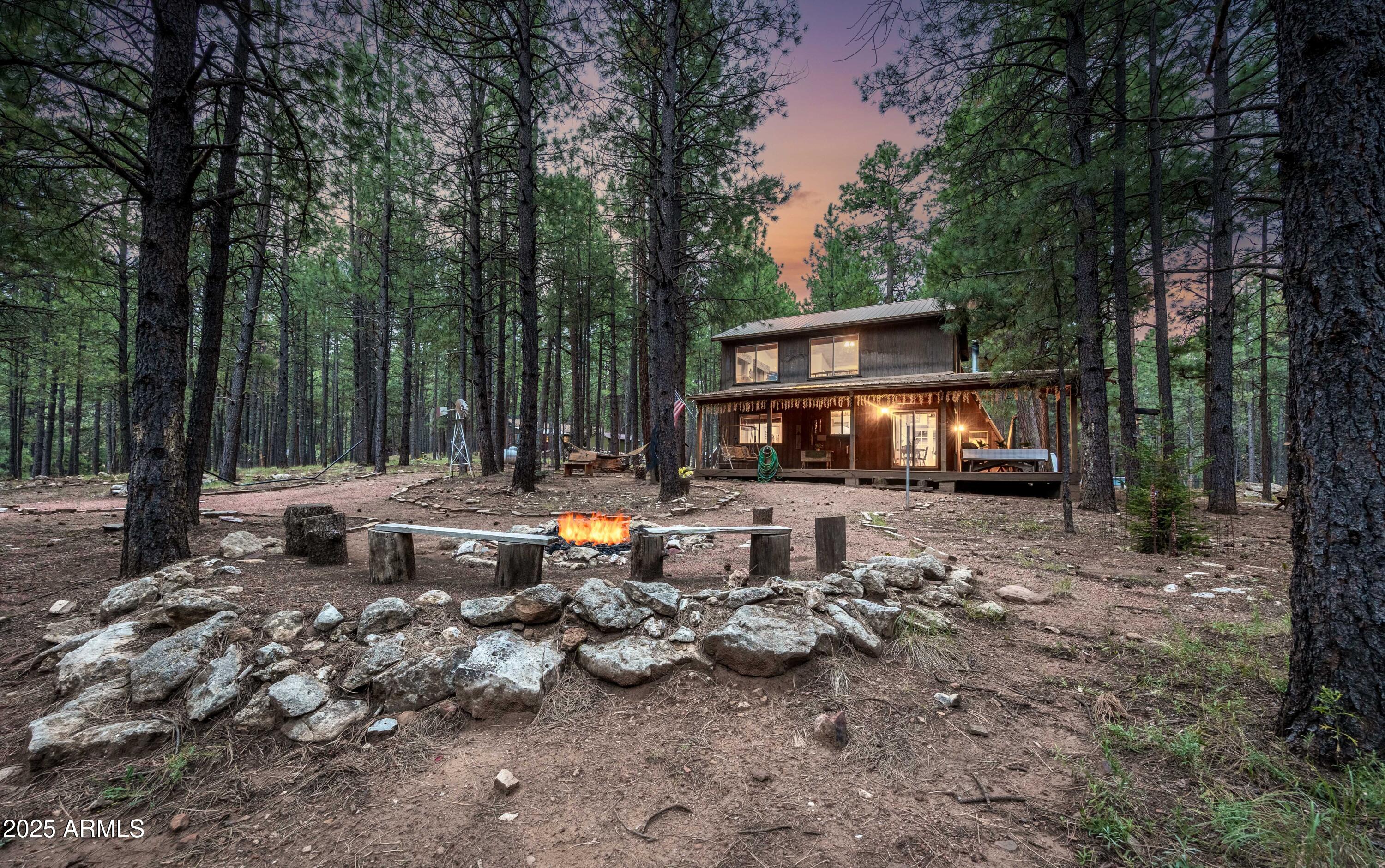 Discover the quintessential mountain retreat at 1643 Rifle Way, where rustic charm meets contemporary comfort on an expansive 1.328-acre at the end of a cul-de-sac in the coveted Forest Lakes community. This distinctive 1-bedroom, 2-bathroom A-frame cabin, enhanced by a thoughtful 2004 addition, presents 1,692 square feet of meticulously crafted living space that seamlessly blends original architectural character with modern functionality.  The property's crown jewel lies in its remarkable outdoor space, positioned at the tranquil end of a quiet cul-de-sac. The generous lot showcases non-native spruce trees among the tall ponderosa pines that is enhanced by an amazing trex deck perfect for entertaining or peaceful contemplation. Inside, soaring vaulted ceilings and tongue-and-groove construction create an atmosphere of mountain sophistication. The eat-in kitchen features multiple windows that frame nature's ever-changing seasons complemented by abundant storage including a large pantry. The primary bedroom includes an ensuite bathroom, while the spacious loft offers a full bathroom a rare and valuable feature in mountain properties. The original A-frame houses a cozy family room with wood burning stove and an additional sleeping loft, providing flexible accommodation options - Second Bedroom.

Practical amenities include inside laundry facilities, while charming details like custom window valances and artistic wall murals celebrate the mountain lifestyle aesthetic. Adding value to this remarkable property is an original 1960s house structure that presents numerous possibilities for enhancement and utilization. This authentic vintage building can serve as a restorable guest house for additional accommodation [when alternative septic was added for addition they ran line to this home, buyer to verify], providing expanded hosting capabilities for family and friends. Alternatively, it functions perfectly as a storage shed for equipment and seasonal items. Plus there is an ATV garage for recreational vehicles and outdoor gear, or a dedicated workshop space for crafts and projects.

The property's location within Forest Lakes provides access to trout-stocked waters including nearby Willow Springs Lake and Woods Canyon Lake, offering premier fishing opportunities just minutes away. 

Forest Lakes sits majestically atop the Mogollon Rim, delivering temperatures 30-50 degrees cooler than Phoenix while remaining just a scenic two-hour drive from valley locations. Full time Fire Department, library and a voluntary homeowners association that features a community center and no mandatory HOA fees.

This exceptional offering represents more than mere real estate it embodies a lifestyle transformation where mountain tranquility meets recreational abundance, creating the perfect year-round retreat for buyers seeking authentic Arizona high-country living.