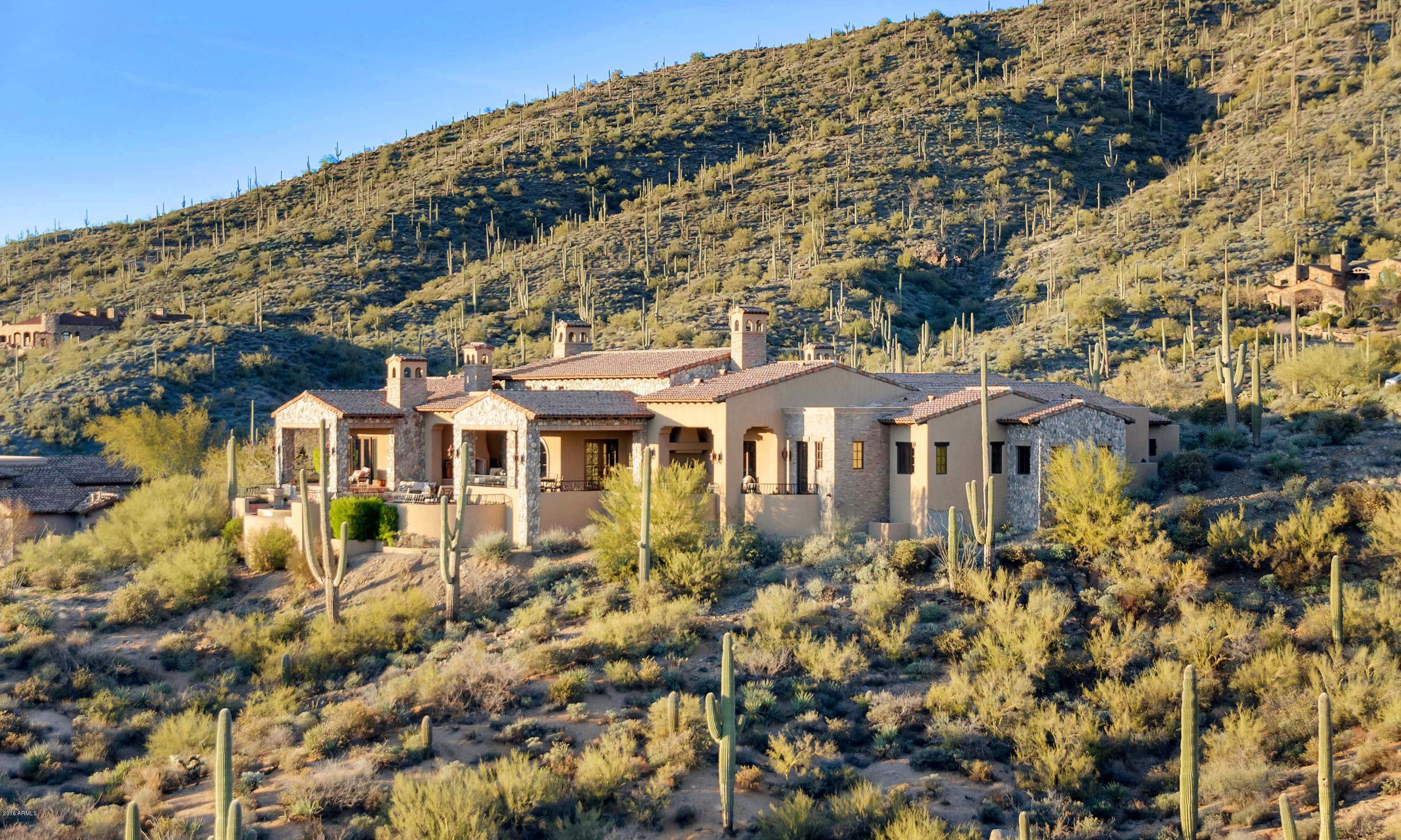 Exquisite home on over 1.7 acres in the premier village of Saguaro Forest with striking views of city lights, mountains and sunsets. Perched amidst the high Sonoran Desert and backing to over 10 acres of open space.  The main house offers an open great room floor plan with three suites, bonus room, study, media room, 2 half baths, wine cellar and a three car garage.    The detached casita has a comfortable living room, a bedroom with full bath plus a two car garage.  The finishes are some of the finest one will find from the Venetian plastered walls, the hand carved beams imported from Indonesia, to the reclaimed beam header in the dining room from a palace in Western India.   An exceptional value and truly a must see for views, value and floor plan.