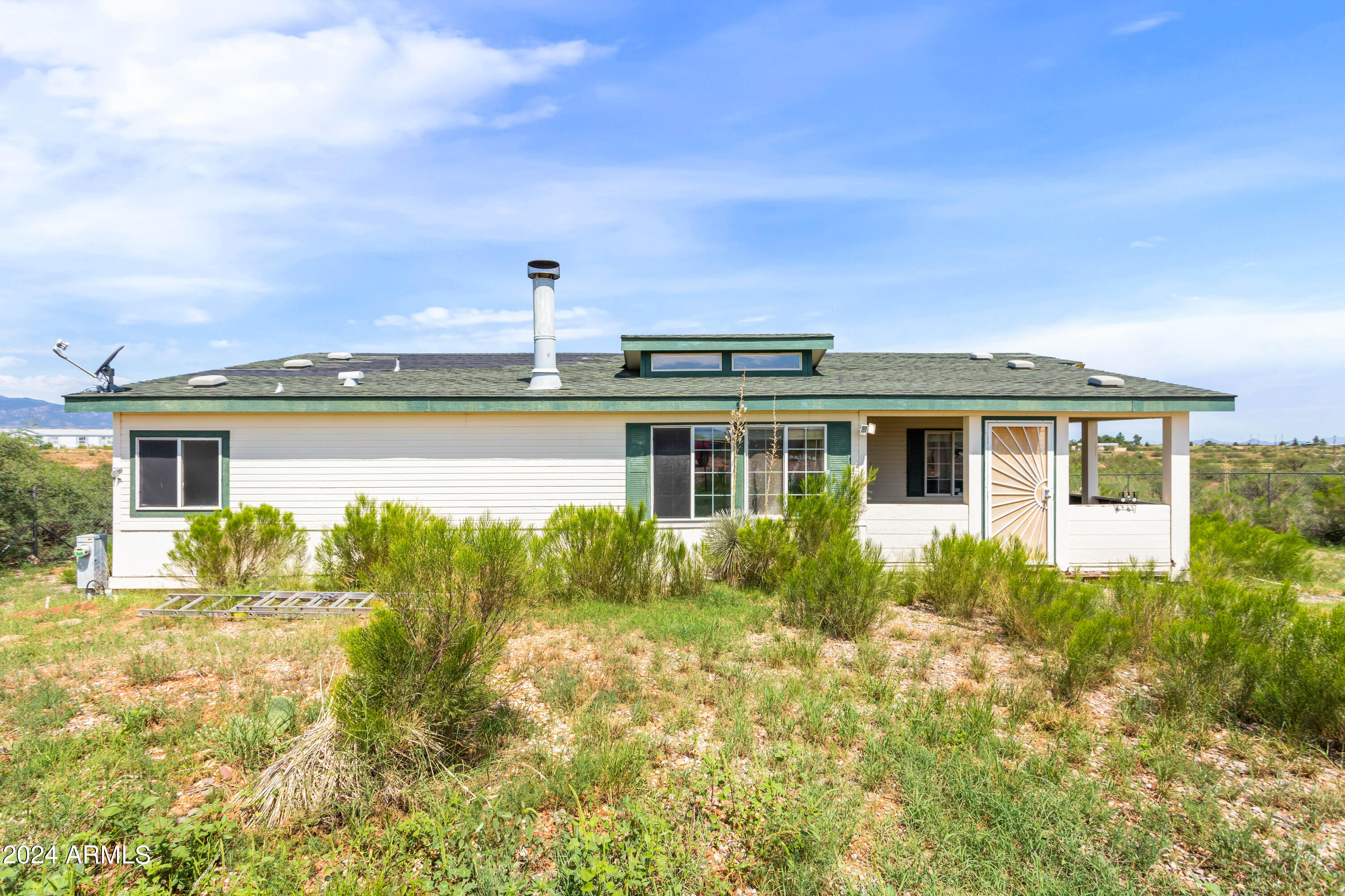 4 bedroom 2 bath manufactured home sitting on just shy of 4 acres. Enjoy the serene setting and mountain views all around this property. Enjoy watching all this property has to offer from sunrises to sunsets to the amazing monsoon storms rolling around the county. The almost 2000 sq ft home has all the space you could need and includes 2 covered patios. Bring your animals and make this place home today. The amazing price of this home reflects the property is being sold AS IS.