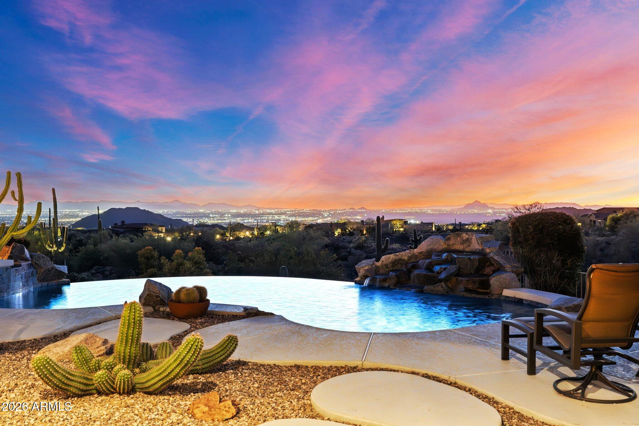 Located within the prestigious gated Diamond Point enclave of Las Sendas, this distinctive Southwest estate captures sweeping Phoenix Valley views to Camelback Mountain and beyond, with sparkling city lights across the desert sky at night. A curated desert cactus garden creates a sculptural sense of arrival and retreat from the moment you enter. Designed for quiet mornings, sunset gatherings, and seamless indoor-outdoor living, the home features soaring ceilings with exposed wood vigas, graceful curved walls, and expansive windows framing dramatic desert views. The inviting patio, negative-edge pool, and spa create an exceptional setting for relaxing or entertaining beneath the glow of Arizona sunsets and city lights. Life in Las Sendas places you within one of Northeast Mesa's premier master-planned communities, offering resort-style amenities, a Las Sendas Golf Club championship golf experience, community pools, pickleball, parks, and a vibrant calendar of social activities, all surrounded by the extraordinary beauty of the Sonoran Desert.
Nearby access to Tonto National Forest, Salt River, and Saguaro Lake creates endless opportunities for hiking, boating, kayaking, tubing, and exploring the landscape that makes this corner of Arizona so special. Convenient access to Phoenix Sky Harbor International Airport and Phoenix-Mesa Gateway Airport, along with nearby medical centers, shopping, dining, and everyday services, allows residents to enjoy both tranquility and convenience.
For those seeking a home that combines architectural character, extraordinary views, outdoor living, and the feeling of a true desert retreat within a connected community environment, this Diamond Point residence represents a rare opportunity within one of the Phoenix Valley's most distinctive hillside neighborhoods.