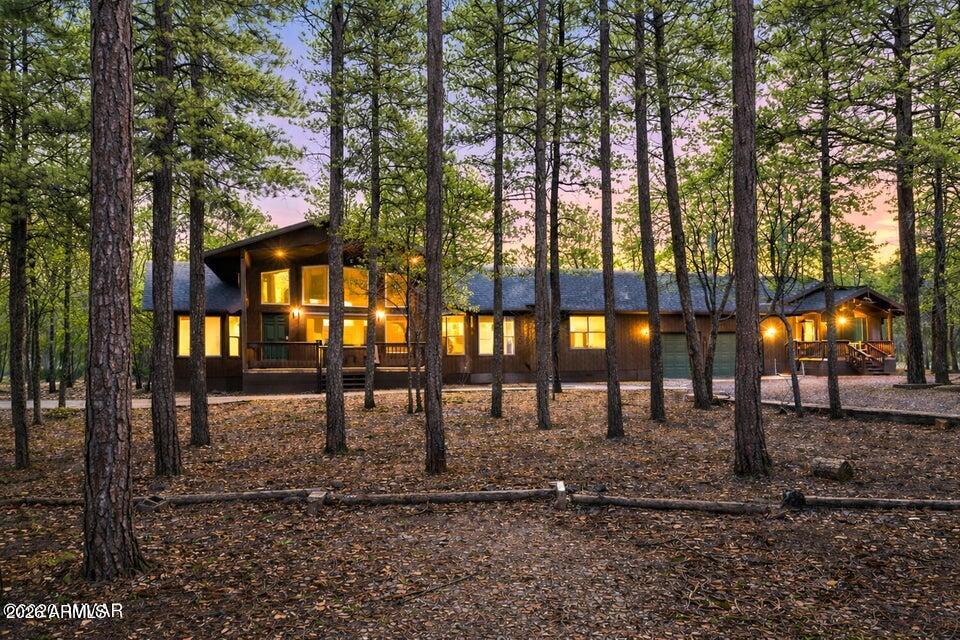 Welcome to your dream mountain getaway. This beautiful custom single level home offers 3,721 sq ft of versatile living space on +/- .97 acres in a quiet cul de sac surrounded by tall pines with no HOA. The main home features vaulted ceilings with rich tongue and groove accents and a total of five bedrooms, including a spacious bonus or bunk room with its own bathroom, perfect for family, friends, or guests. The kitchen is designed for both style and function, and the laundry and mudroom with built ins keep everything organized. Forced air and central AC make it easy to enjoy year round comfort. The separate 963 sq ft casita is a true gem with a full kitchen, walk in pantry, washer and dryer, and accessibility ramps, making it ideal for extended family, friends, or income potential.