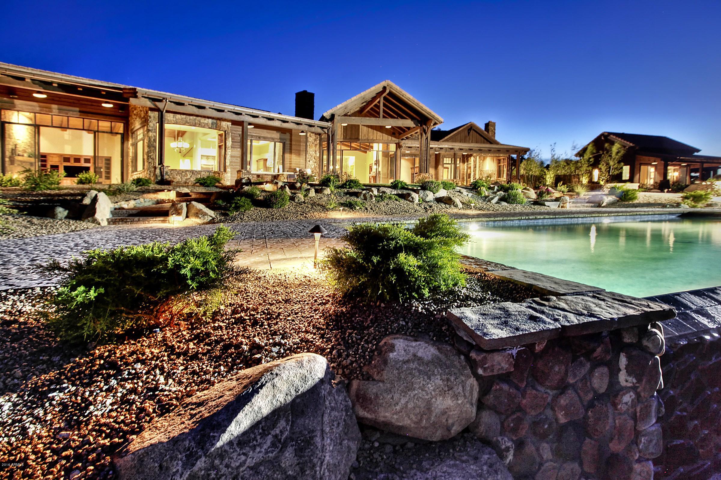 FROM THE FIRST LIGHT OF DAWN TO THE DARK OF A STARLIT NIGHT, THE 270 DEGREE VIEWS OVERLOOKING THE ENTIRE CITY AND AS FAR AS THE SAN FRANCISCO PEAKS, WILL QUITE LITERALLY TAKE YOUR BREATH AWAY!!!!. This incredibly beautiful home and guest retreat sit atop an astonishing 3.35 acres of level landscaped property high above Prescott in the exclusive Hassayampa Village Community. Whether you're standing at one of the many floor-to-ceiling windows in the main house, or relaxing on the huge picturesque porch, you can enjoy the stunning glory of the perfectly placed infinity saltwater pool and spa where the water disappears into a skyline for miles but not without ultimate privacy. The dramatic first impression offers 6050 sf in the main house and 950 sf in the guest home all main level living. Quality craftsmanship is evident from the dramatic groin vault entry ceiling, the Antique Ash wood flooring, tonque-in-groove ceilings and the 5 massive masonry fireplaces with hand selected stone. The theme is rustic elegance and luxury throughout. See special features sheet and information on the property and the Capital Canyons Country Club memberships.