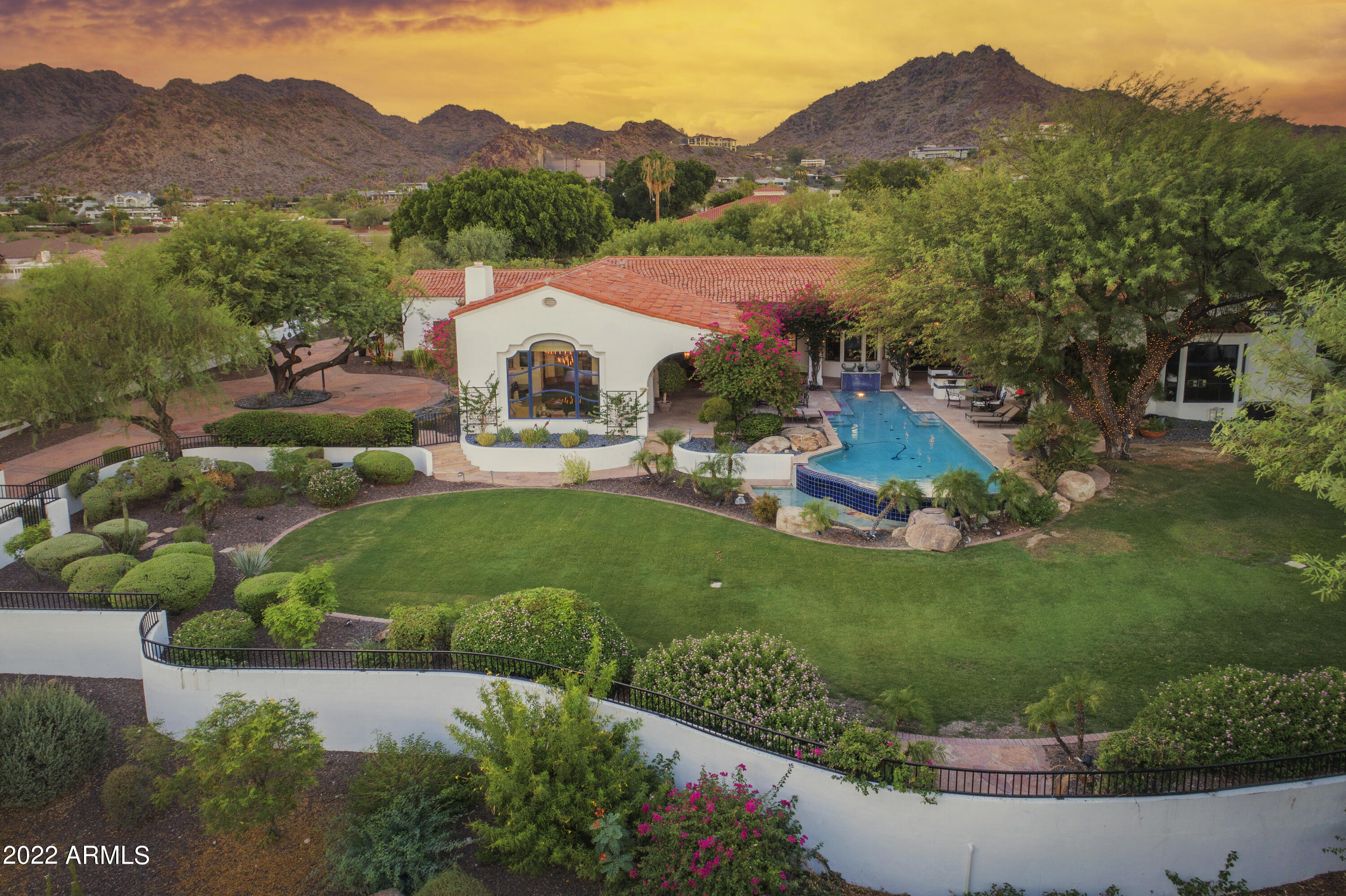 This privately gated Cal Christiansen masterpiece is an entertainer's dream. As you enter this elegant Santa Barbara style home you are drawn to a charming courtyard that envelopes your own lap pool, while each room features its own special view, from city lights to mountain views. Every day will be like retuning to a resort. As you move through the formal living area you will find a relaxed great room with a chef's kitchen and bar perfect for gathering around. Plus, you will notice how the home has been tastefully updated by Genova Development making sure everything is move in ready. The home is simply stunning throughout with so many special touches from Restoration Hardware lighting to a full bar; and other special details such as a resort style Koi Pond and a large yard with big views.