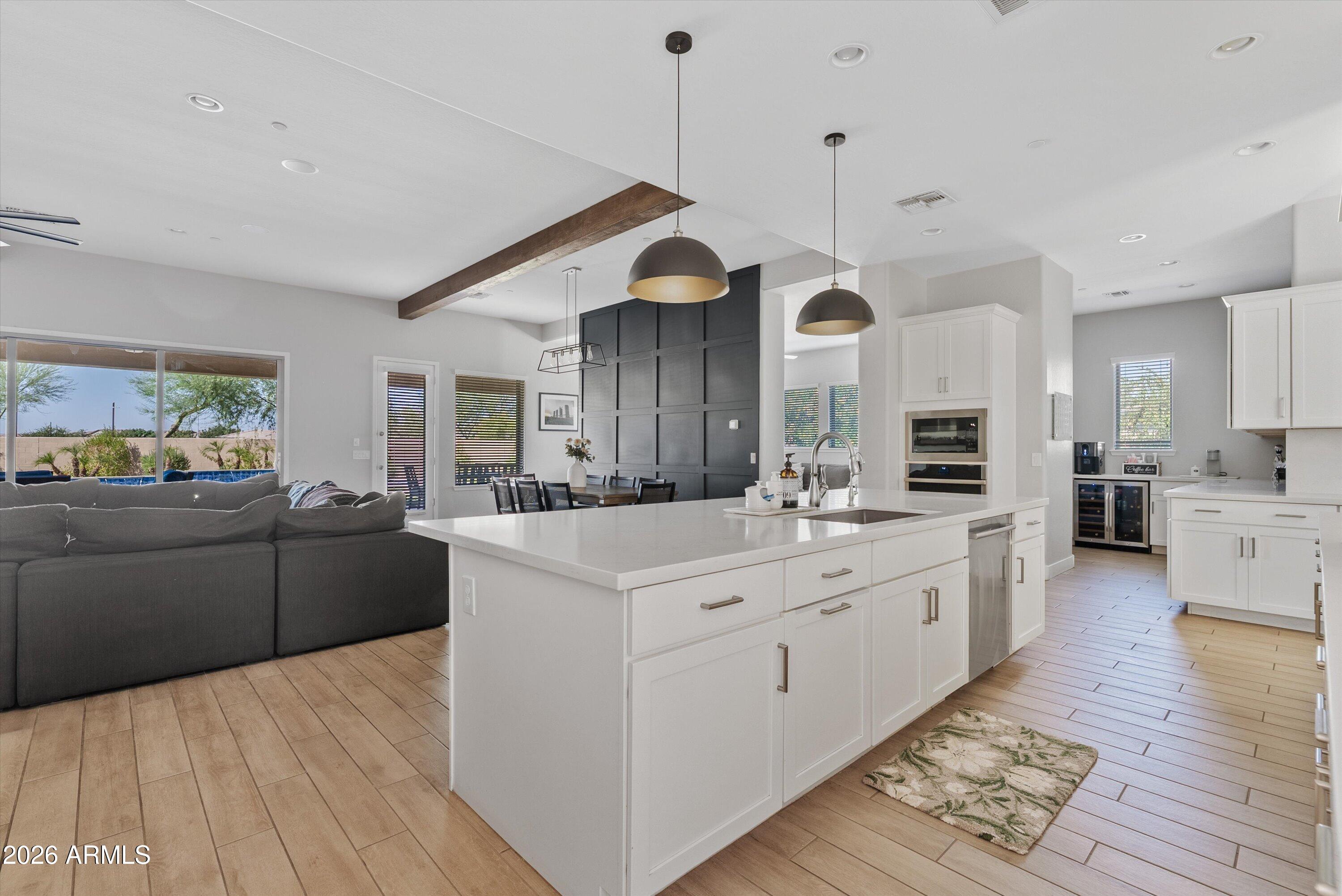 If you've been searching for the sense of community that Eastmark is known for, but desire more space, privacy, and luxury, this is the opportunity you've been waiting for.

Situated on a rare cul-de-sac lot just shy of half an acre, this exceptional David Weekley residence is located within one of Mesa's most sought-after gated communities, where all homes are single story and thoughtfully designed on larger homesites with wider streets and a more refined atmosphere. With no rear neighbors and an expansive four-car garage, this property offers a level of privacy and exclusivity rarely found in today's market.

Inside, the gourmet kitchen anchors the home with high-end finishes, generous gathering spaces, and seamless indoor-outdoor flow designed for both everyday living and effortless entertaining. 

The backyard is nothing short of extraordinary. A sprawling resort-style pool with Baja shelf is framed by an expansive travertine deck, creating the ultimate setting for Arizona living. Host unforgettable gatherings around the built-in BBQ and pergola, enjoy friendly competition on the half-court basketball court, or simply relax and take in the peace and privacy of your oversized homesite.

Offering the community connection and lifestyle buyers love about Eastmark, paired with larger lots, greater privacy, gated security, and luxury single-level living, this home represents a rare opportunity to experience Mesa living at its finest.
