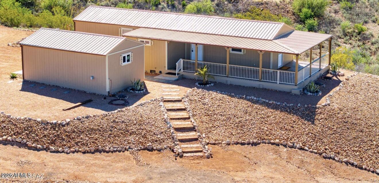Brand new turn key  2 bedroom 2 full bathroom home on just under one acre with detached one car garage with electric located at the end of Cul De Sac in a desirable neighborhood. Full RV hook up with access to electric, water and septic. Open great room layout with new laminate flooring, granite countertops and all new appliances. Features include ceiling fans throughout as well as energy-efficient mini spit systems. Durable metal roof and new septic system. Enjoy a large wrap around covered porch with stunning views and wildlife. Beautiful desert landscaping make this home great to move in and start enjoying.