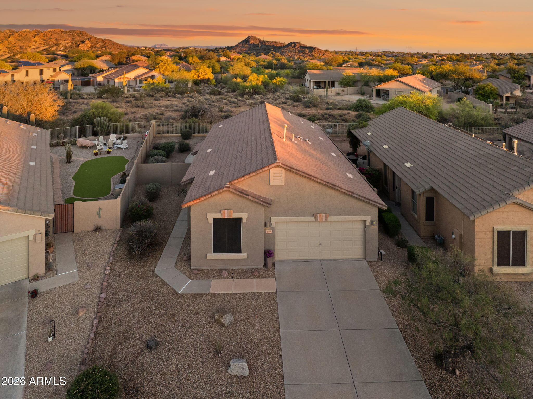 Beautifully updated home nestled near the base of the Superstition Mountains in one of Gold Canyon's most sought-after communities. The thoughtfully designed open kitchen features granite countertops, a large kitchen island, and a buffet/coffee bar, making it perfect for both everyday living and entertaining. A spacious eat-in dining area provides a comfortable setting for casual meals and offers abundant cabinetry for exceptional storage. The expansive primary suite offers a peaceful retreat, complete with a generous walk-in closet. In the family room, soaring vaulted ceilings and a cozy fireplace create a warm, inviting ambiance--ideal for relaxing or gathering with guests. Step outside to your private backyard oasis, where a large covered patio frames views of the Superstition Mountains all while backed to a serene desert preserve--perfect for enjoying Arizona's beautiful sunsets. With low HOA fees, residents enjoy access to outstanding amenities, including a heated community pool and spa, scenic walking and hiking trails, and proximity to multiple golf courses. Plus, boating, kayaking, and fishing opportunities are all within a convenient drive. Welcome Home to your Arizona Retreat in picturesque Gold Canyon at the Foothills of the Superstition Mountains!