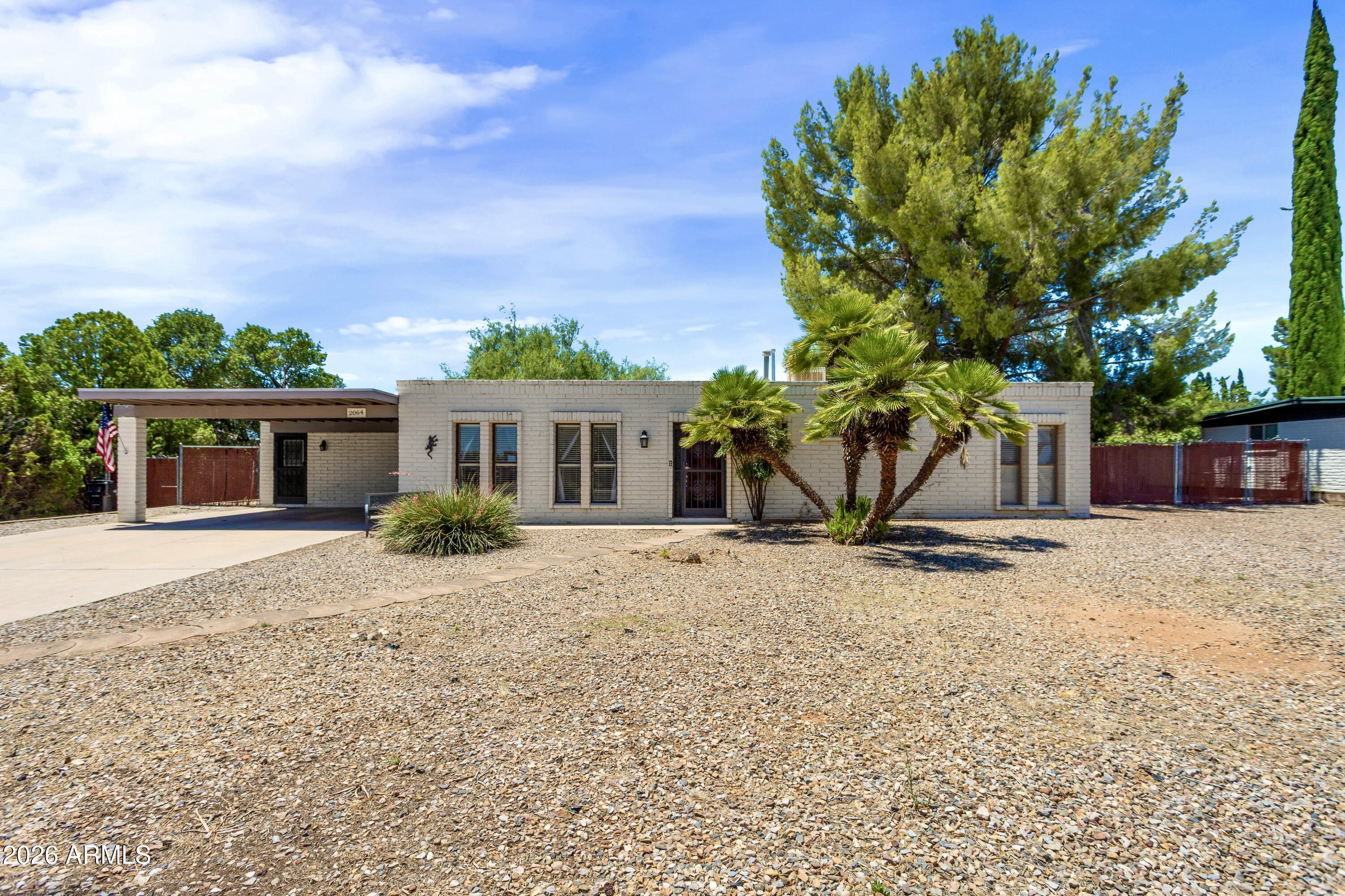Welcome home to this beautifully maintained 3-bedroom, 2-bath home on an oversized residential lot! Featuring tile flooring throughout, this home offers two spacious living areas, including a cozy family room with a stunning stone wood-burning fireplace. The bright sunroom is the perfect place to relax while enjoying views of the mature trees and peaceful backyard. An oversized laundry room with abundant storage, plus an additional storage space, provides the functionality you've been looking for. Centrally located near shopping, dining, schools, and more, this home combines everyday convenience with the privacy and space to truly enjoy.